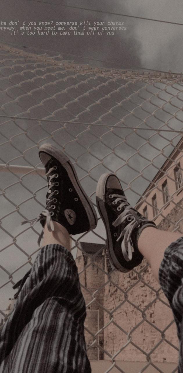 A person's feet are hanging over the edge of something - Shoes