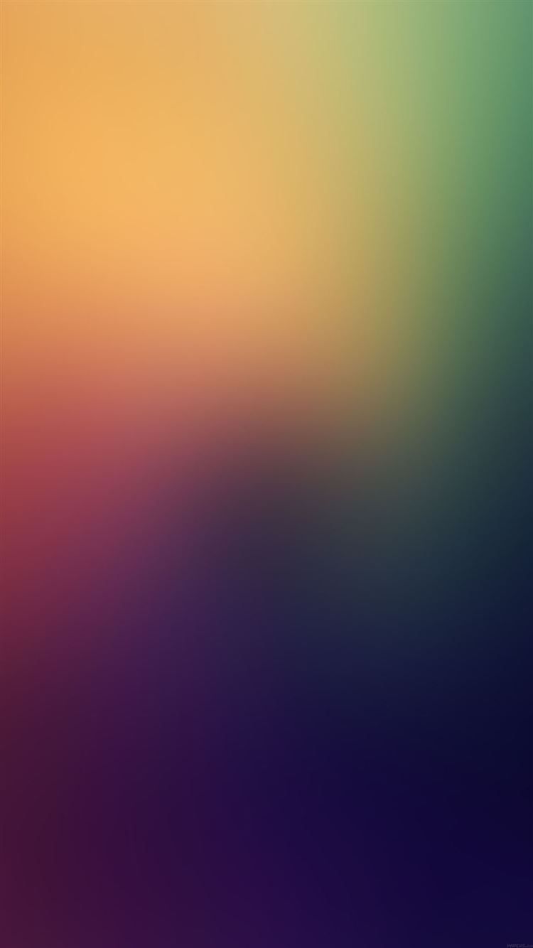 A colorful abstract wallpaper with a gradient of blue, green, yellow, and red. - Blurry