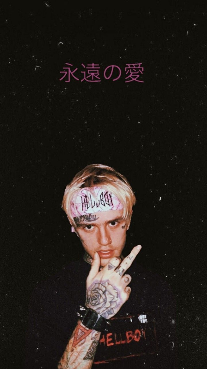 A man with tattoos on his arm - Lil Peep