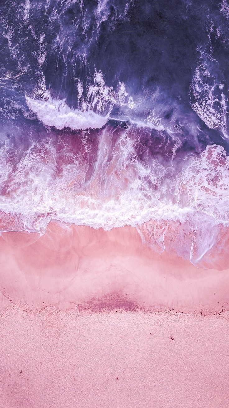 A beach with pink sand and waves - Clean