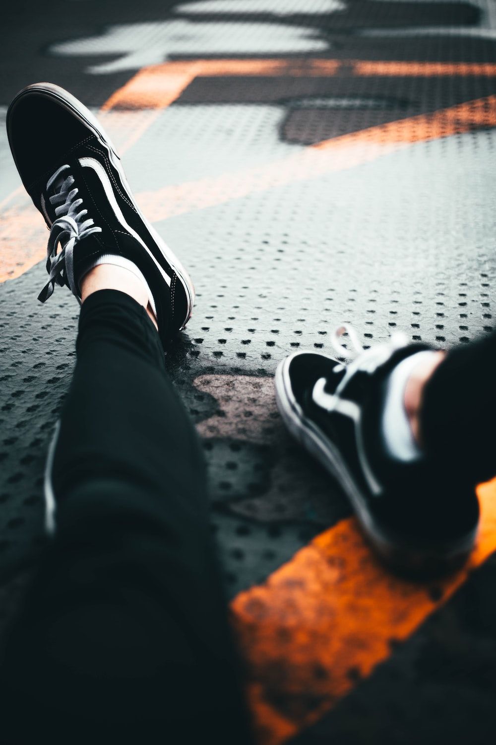 person wearing black and white nike sneakers photo