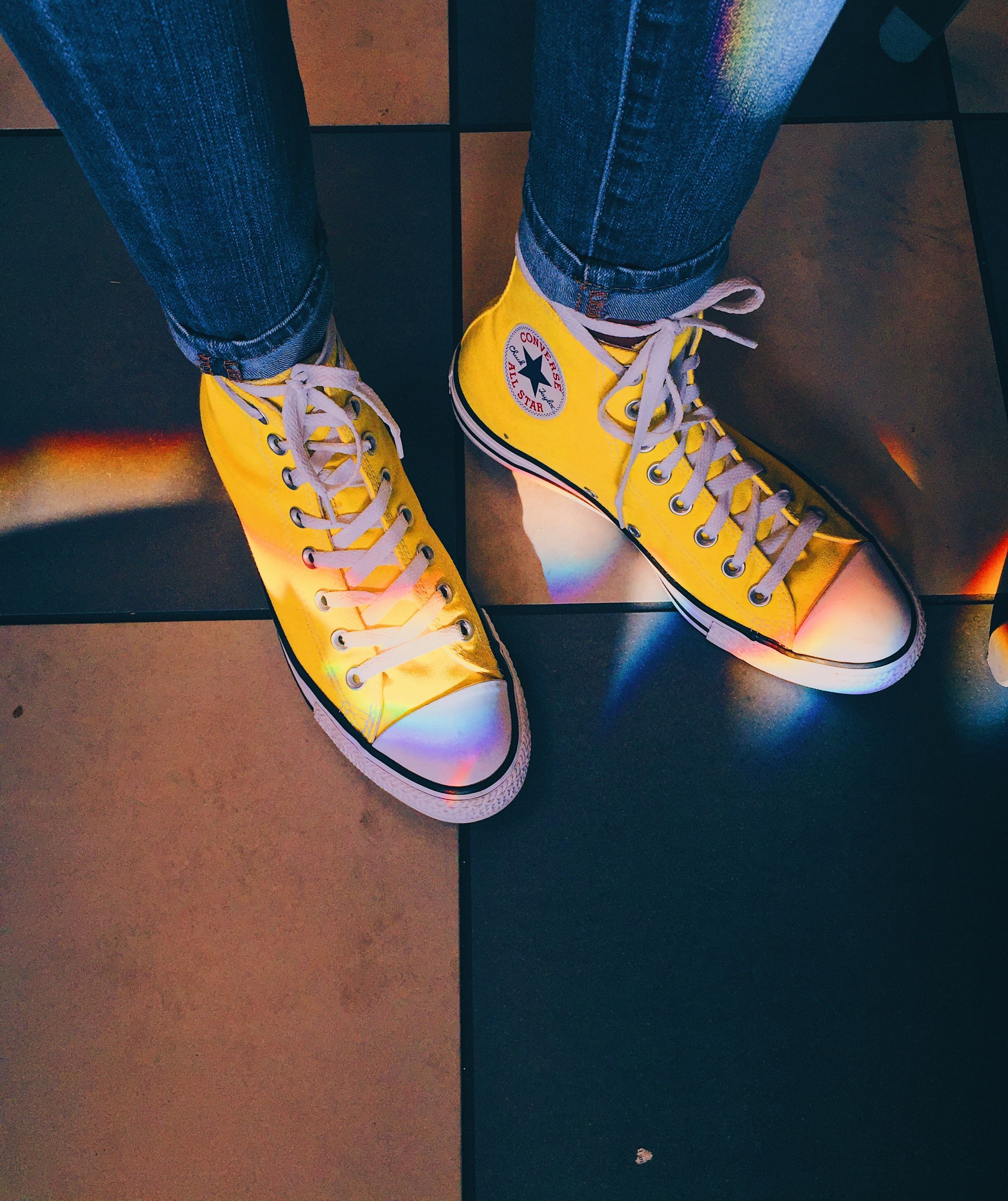 A person wearing yellow converse shoes - Shoes, Converse