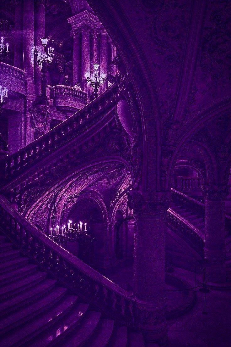 A purple lit grand staircase with candles and chandeliers. - Dark purple