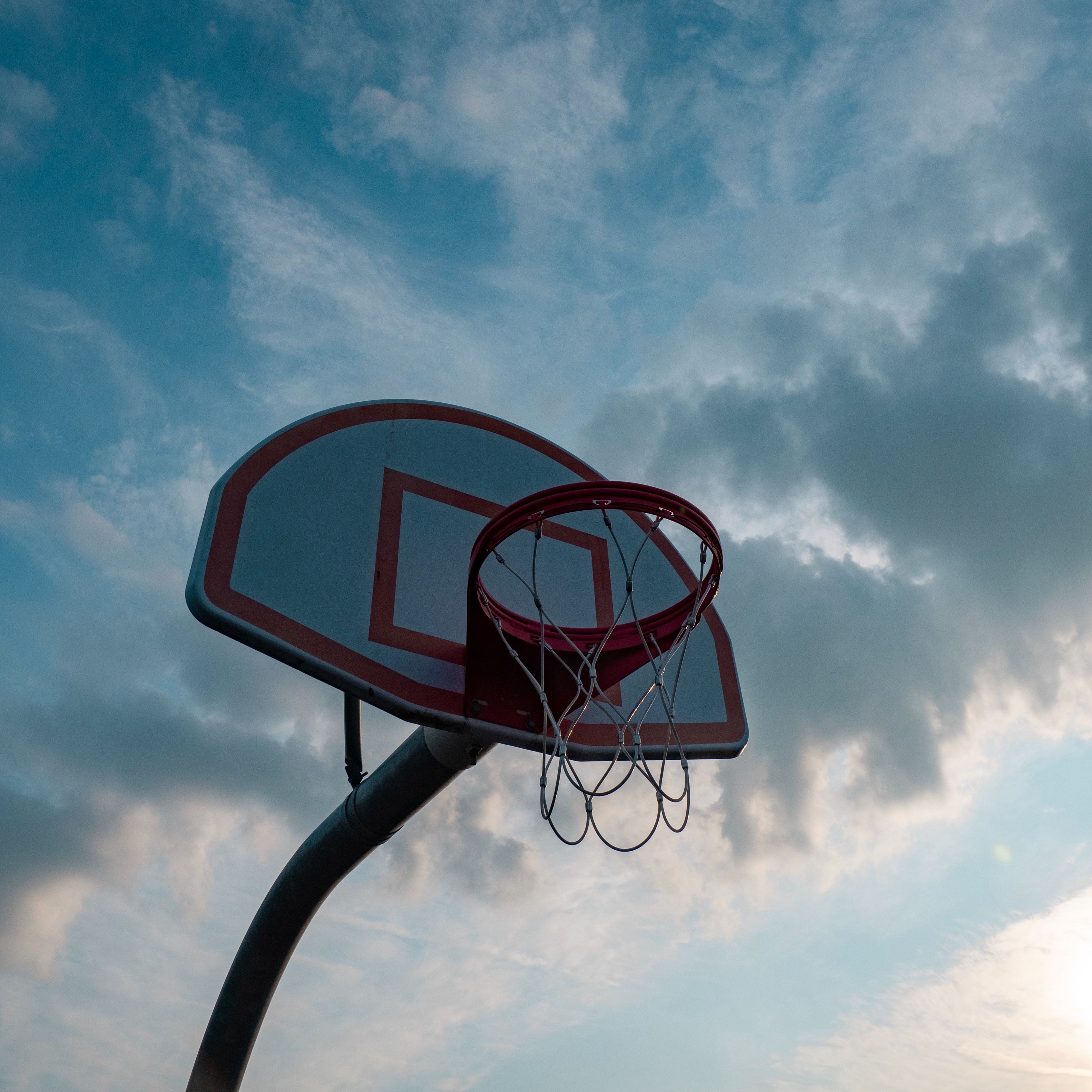A basketball hoop with the sun shining on it - Basketball