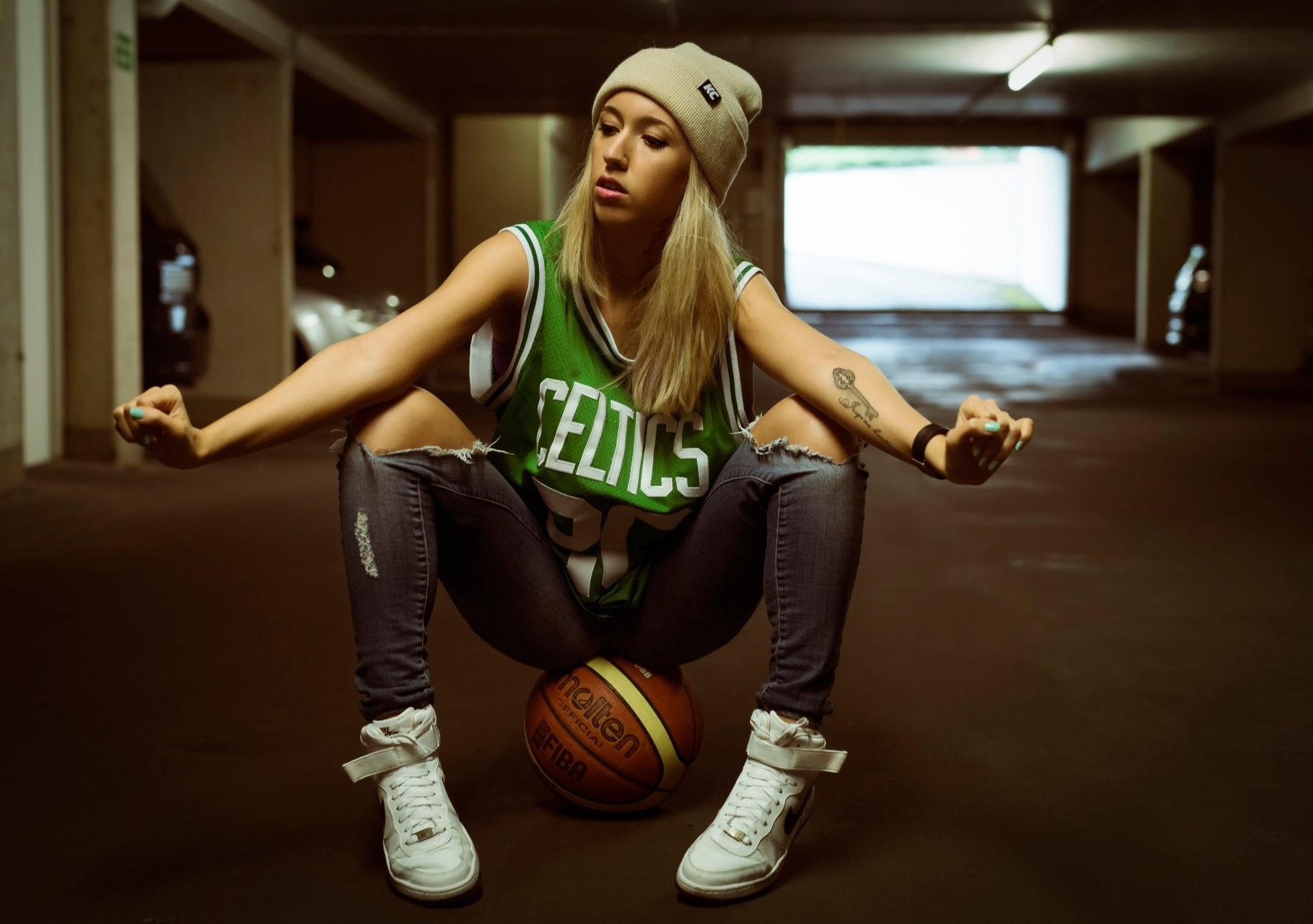 A woman sitting on the floor with her hands in prayer - Basketball