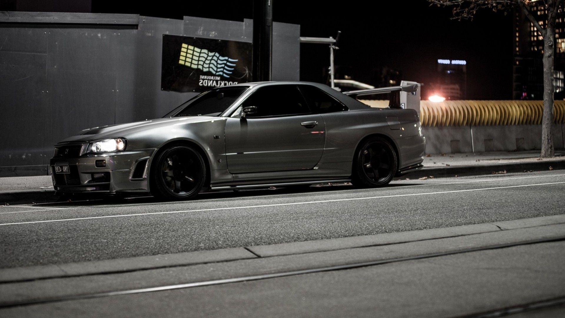 A nissan skyline gtr r34 on the road at night - JDM