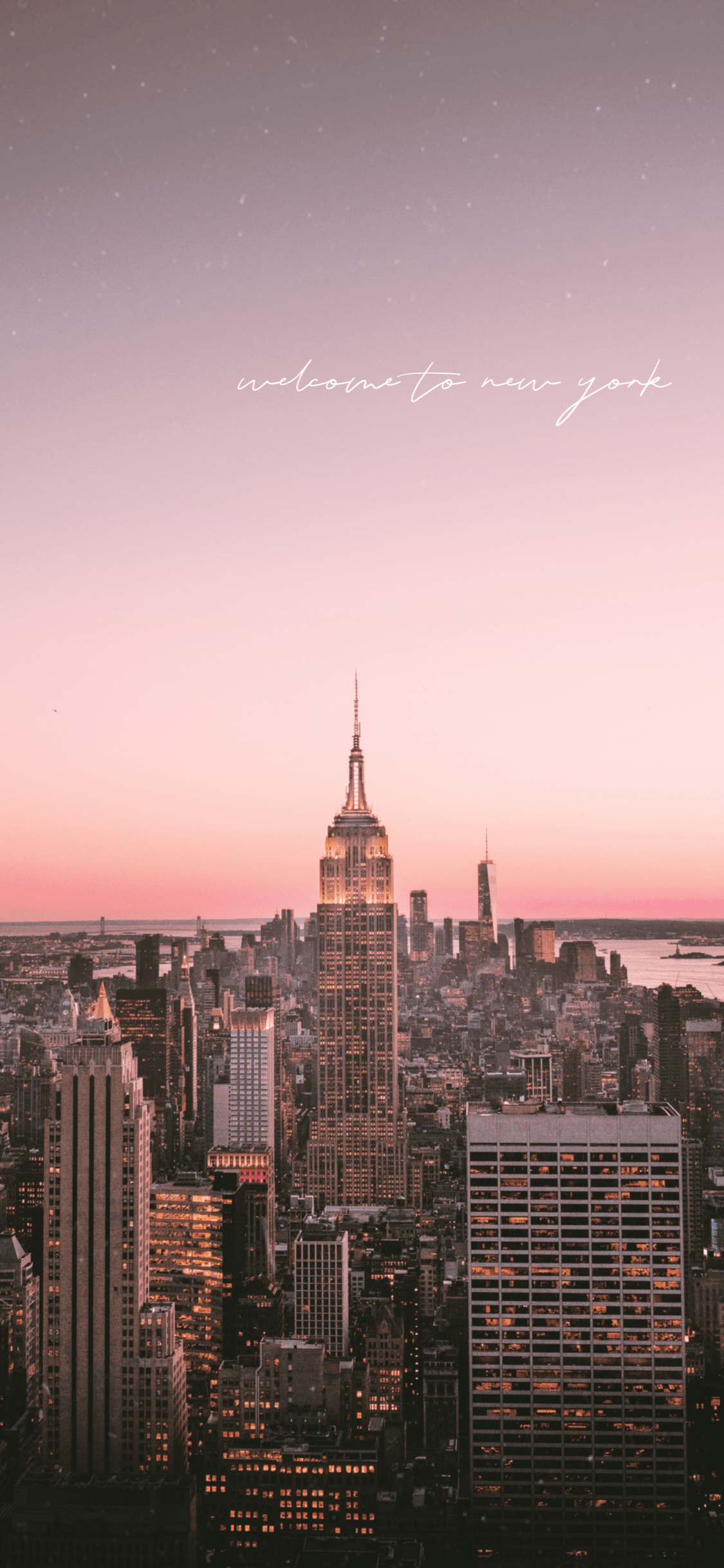 A city skyline at sunset with the words welcome to ny - New York