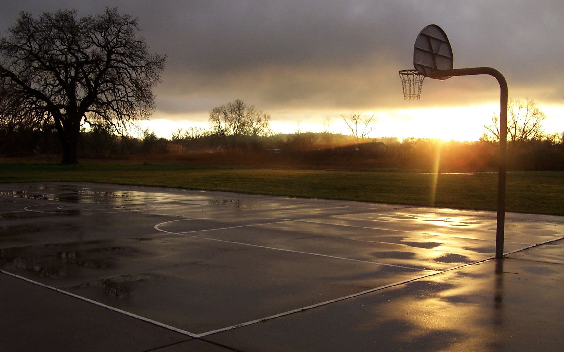 A basketball court with a basketball hoop and net. - Basketball