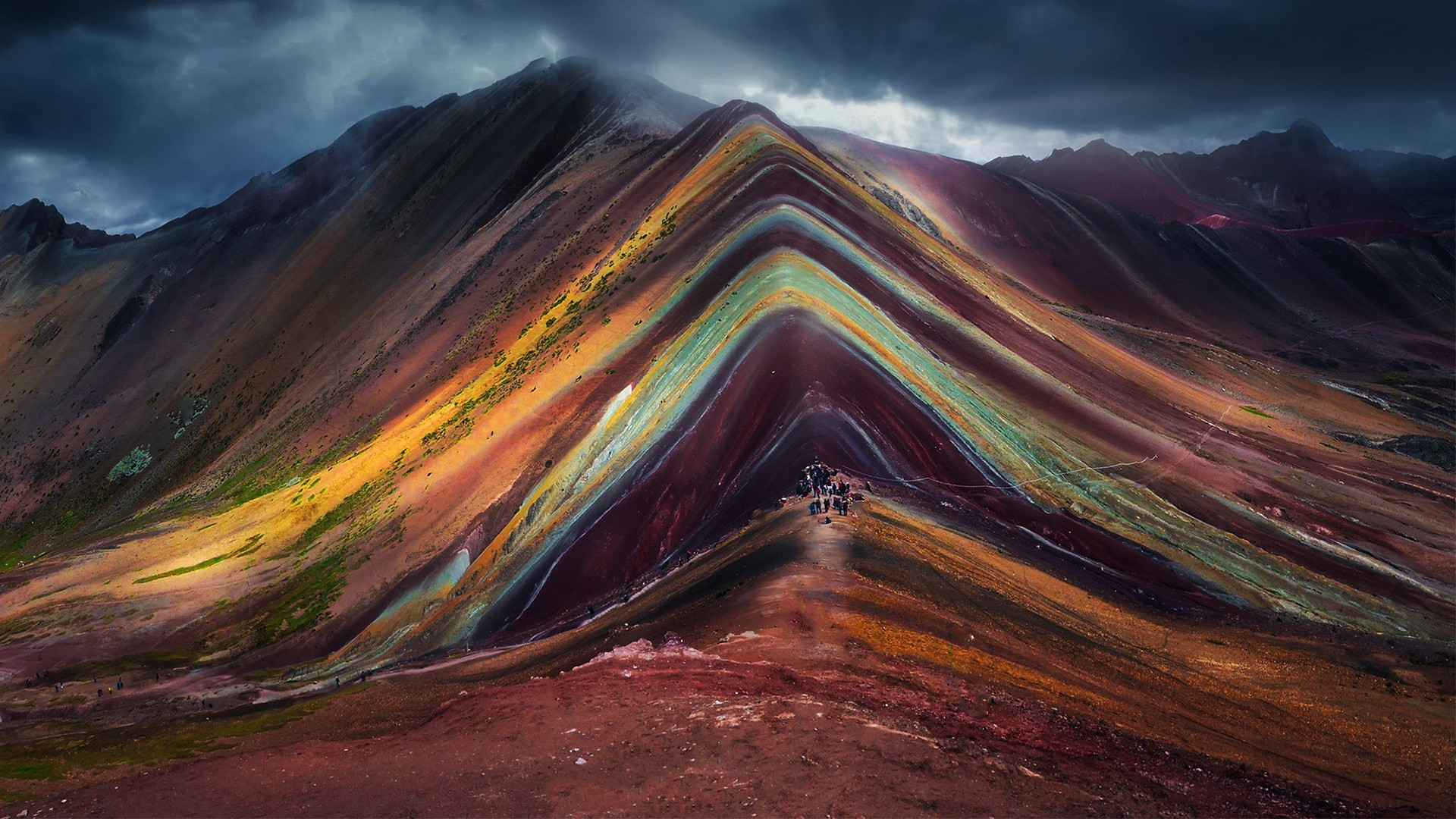A mountain with colorful stripes on it - Mountain