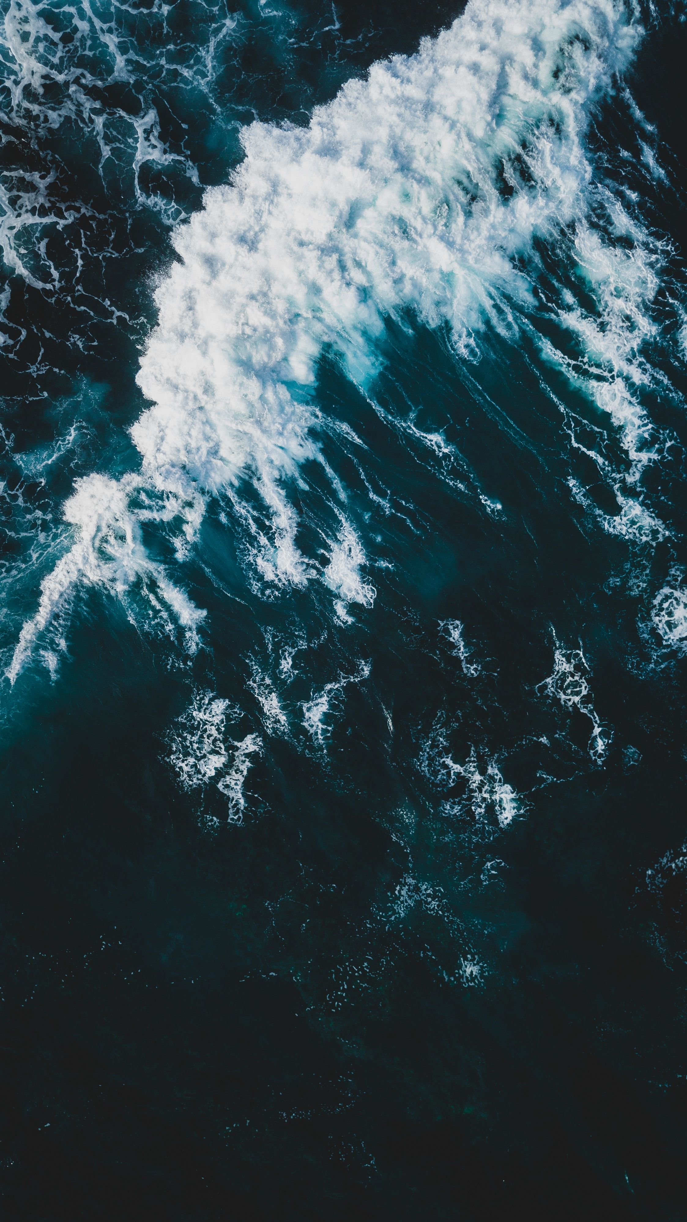 A photo of the ocean from above, with white crests and dark blue water. - Wave, water, ocean, underwater