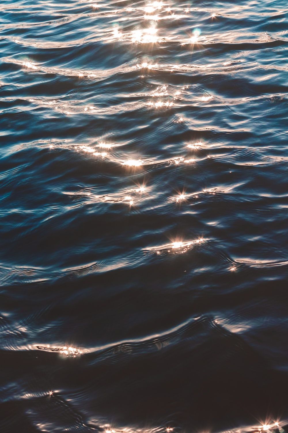 A body of water with sunlight shining on it - Ocean, wave, water