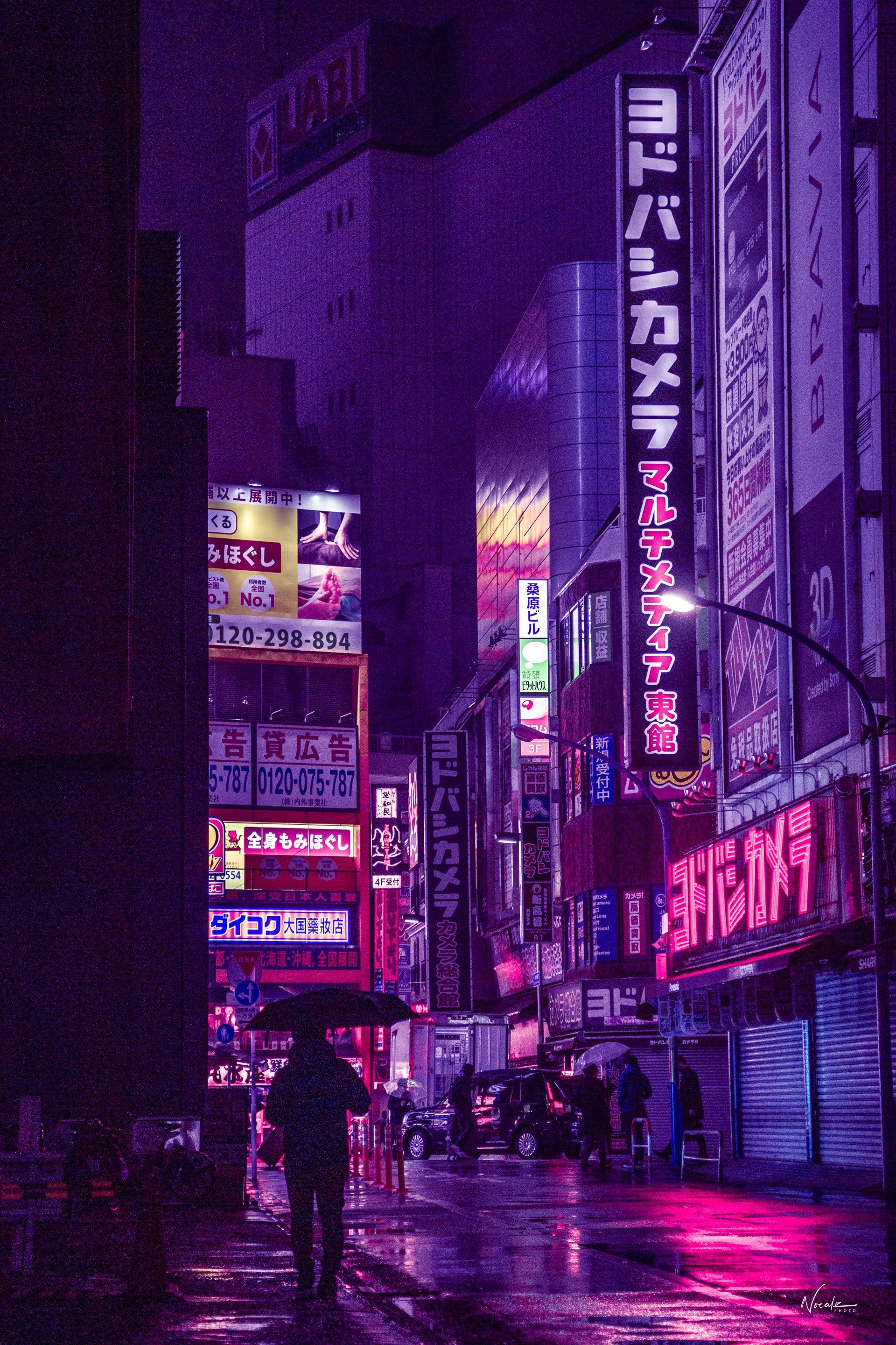 A person walking down the street at night - Tokyo