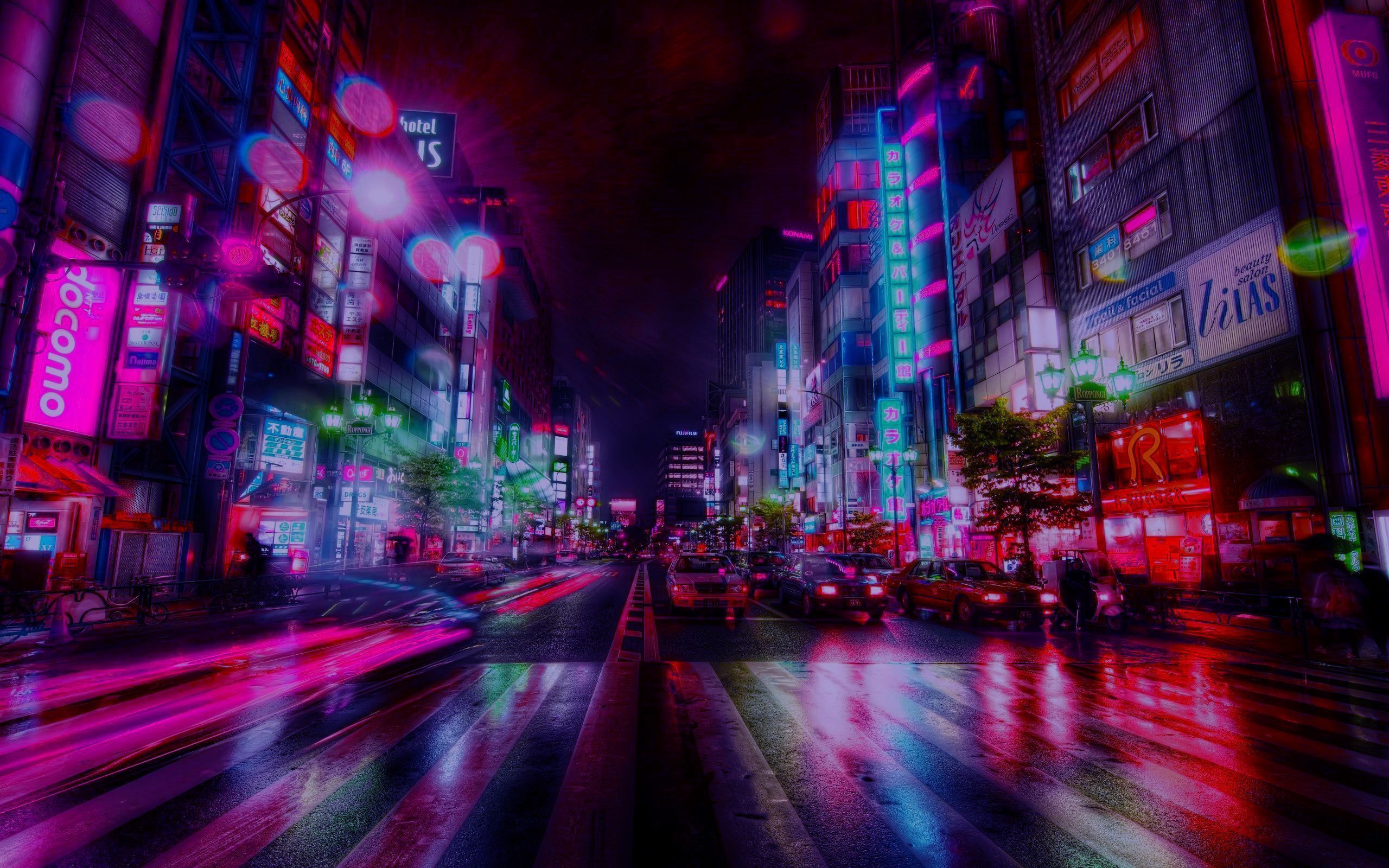 A city street at night with neon lights and traffic - Tokyo