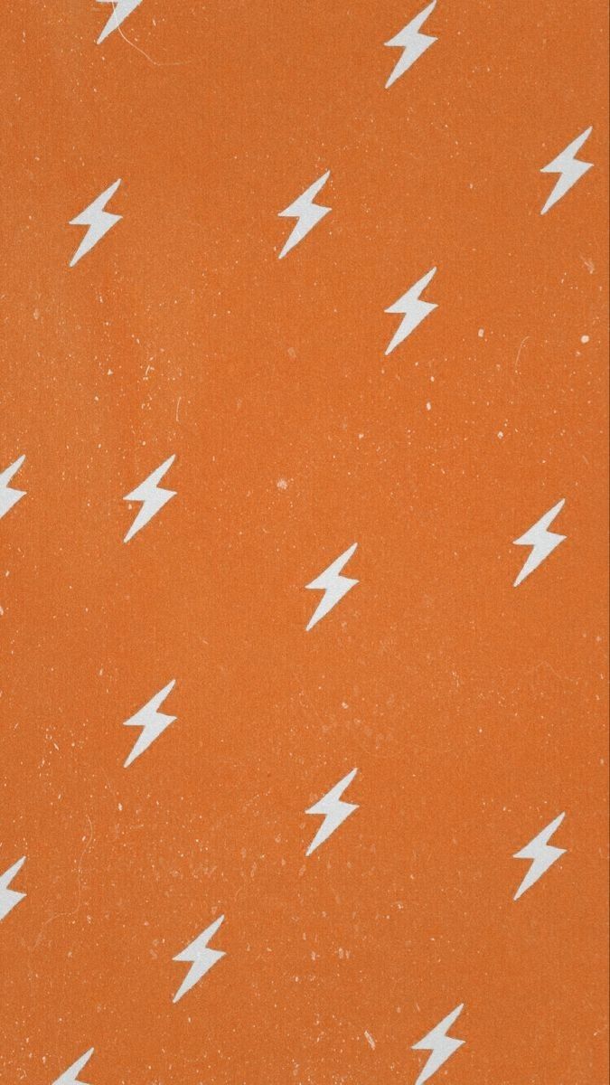 A pattern of white lightning bolts on an orange background - VSCO