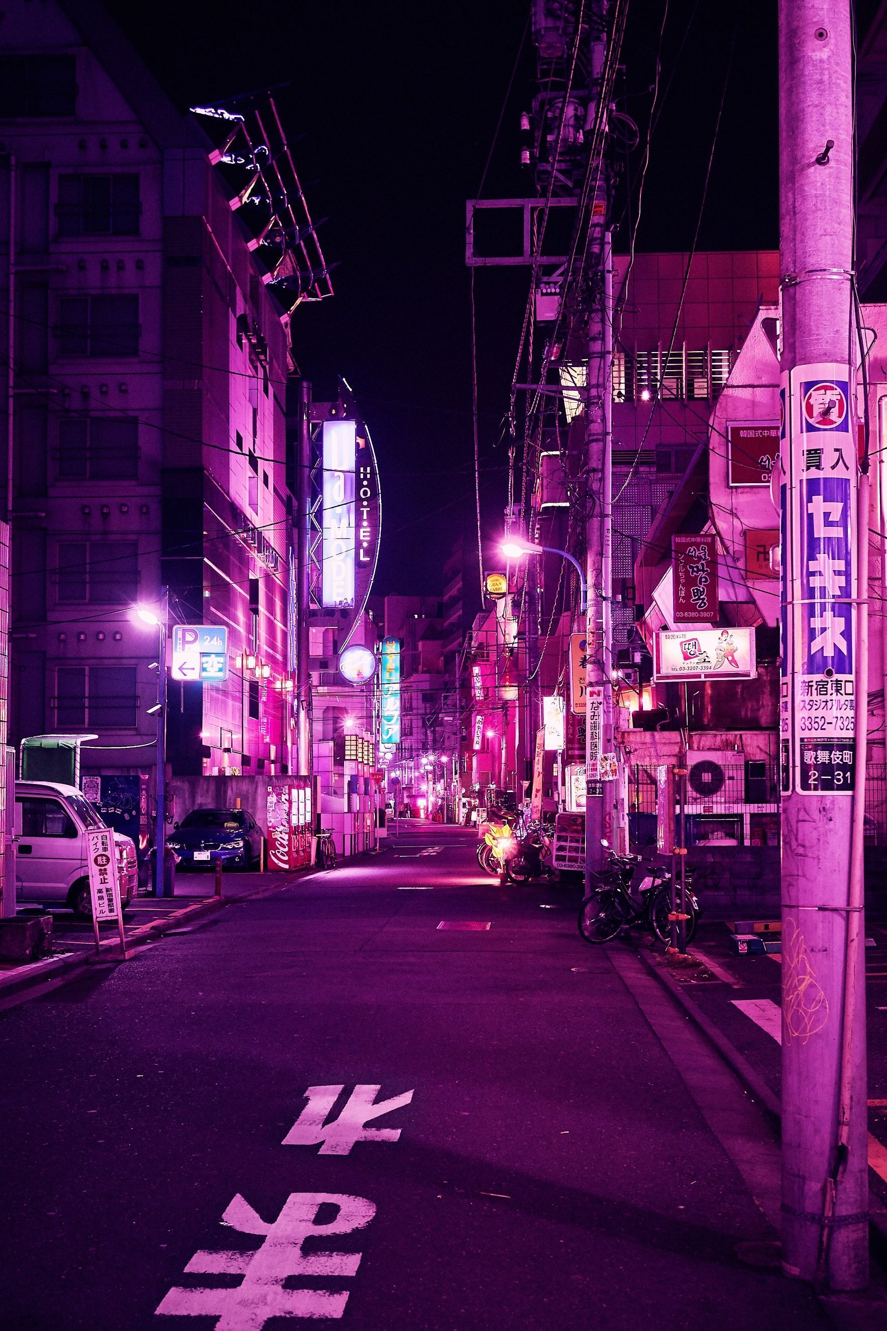 A city street at night with neon lights - Tokyo, Japan
