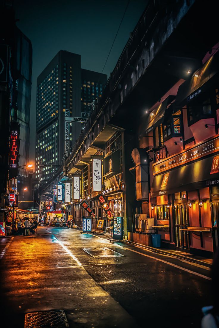 A city street with many buildings and lights - Tokyo
