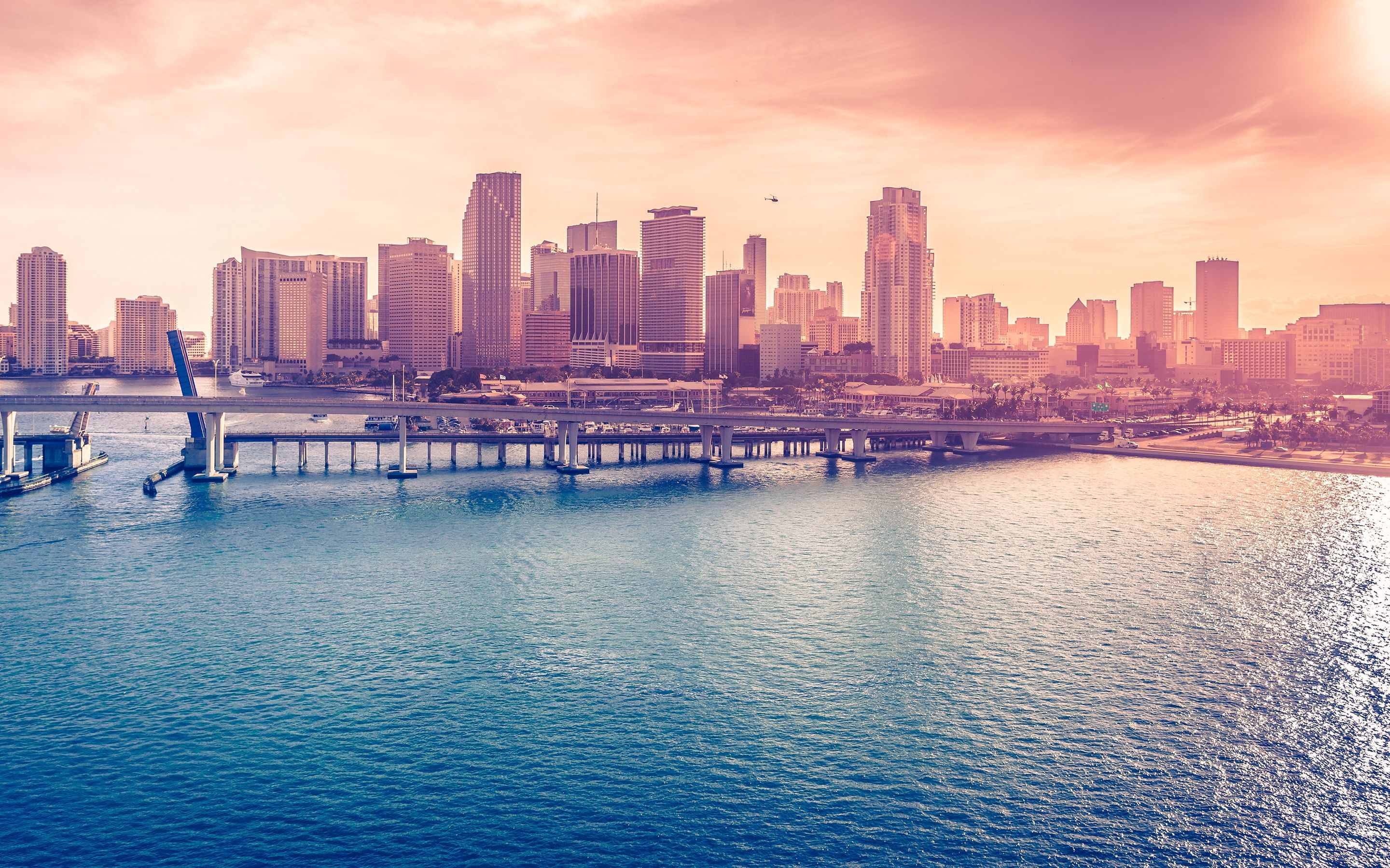 A city skyline with water and boats - Miami