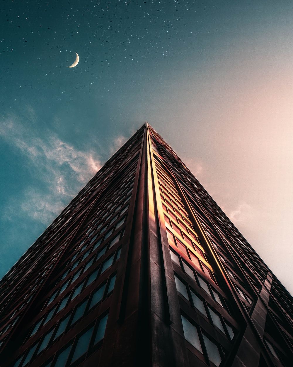 A tall building with the moon in front of it - Chicago