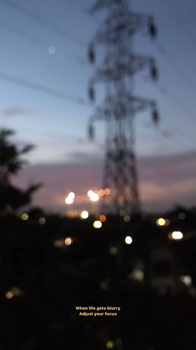 A blurry picture of an electric tower at night - Blurry