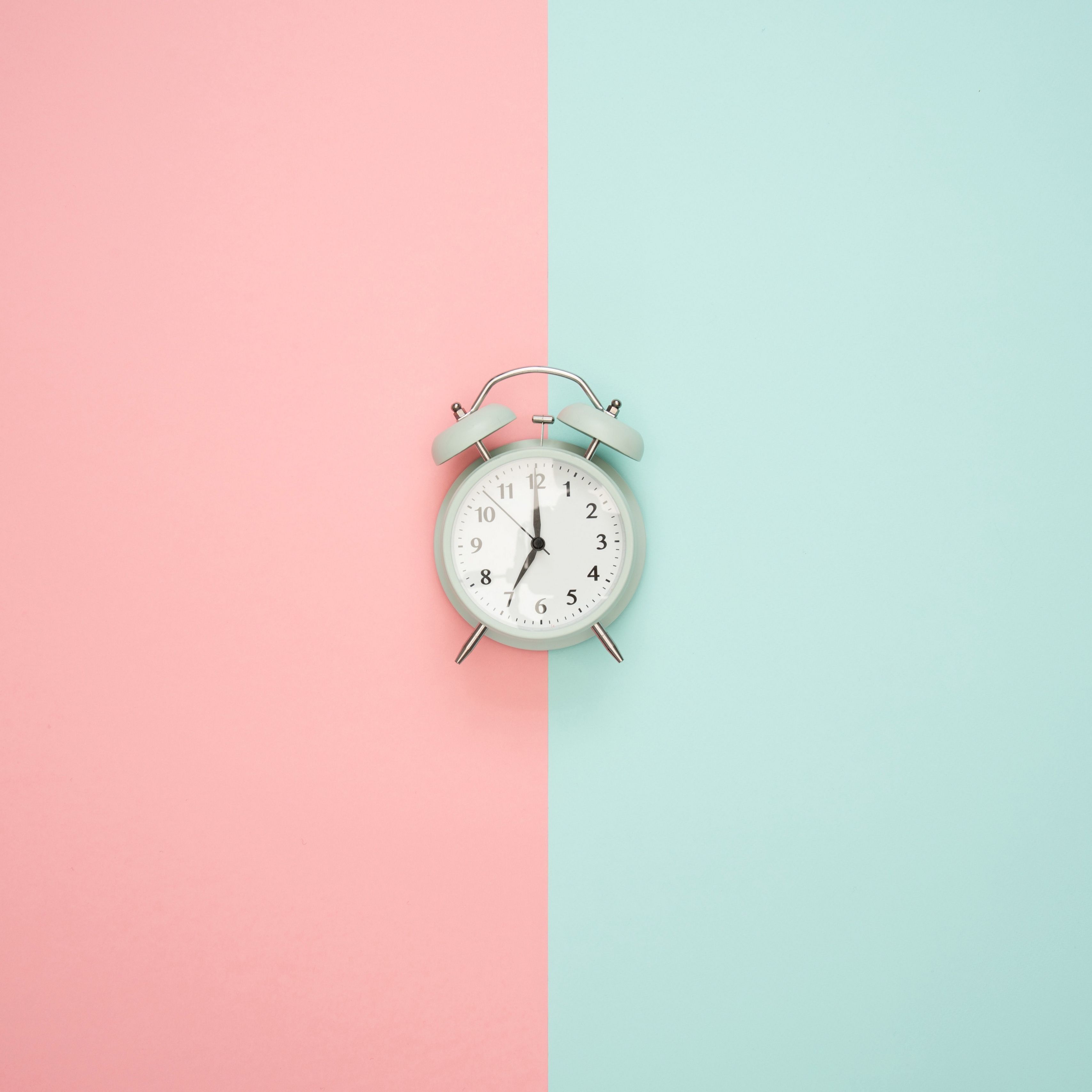 A clock on a pink and blue background - Pastel minimalist