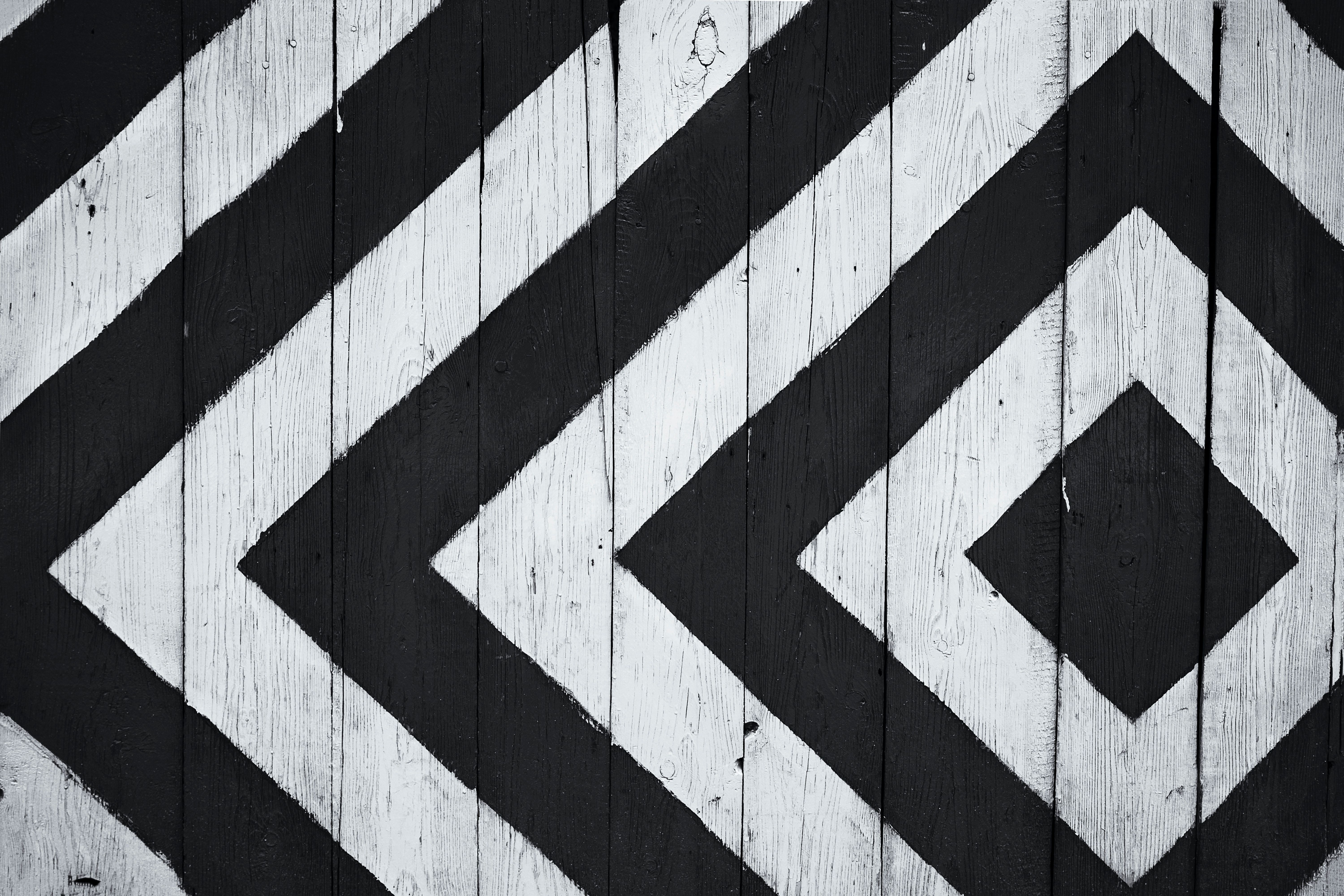 A black and white graphic pattern on a wooden wall - Black and white