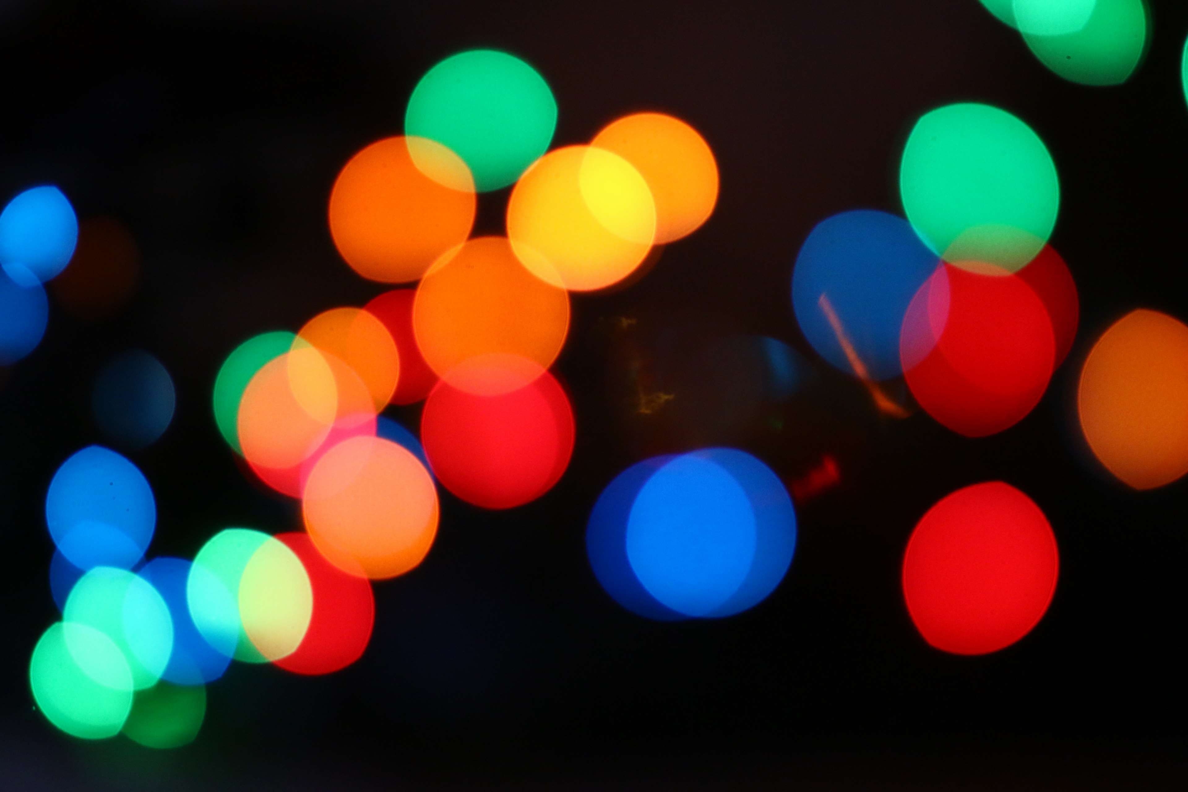 A picture of colorful bokeh lights on a black background. - Blurry