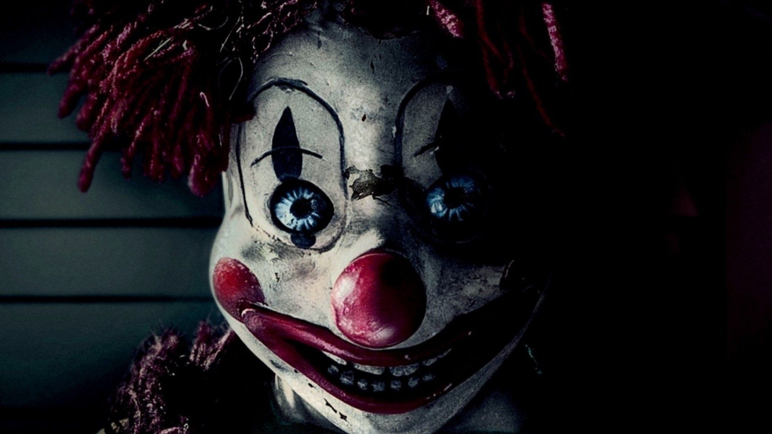 A scary clown doll with red hair and big eyes - Horror