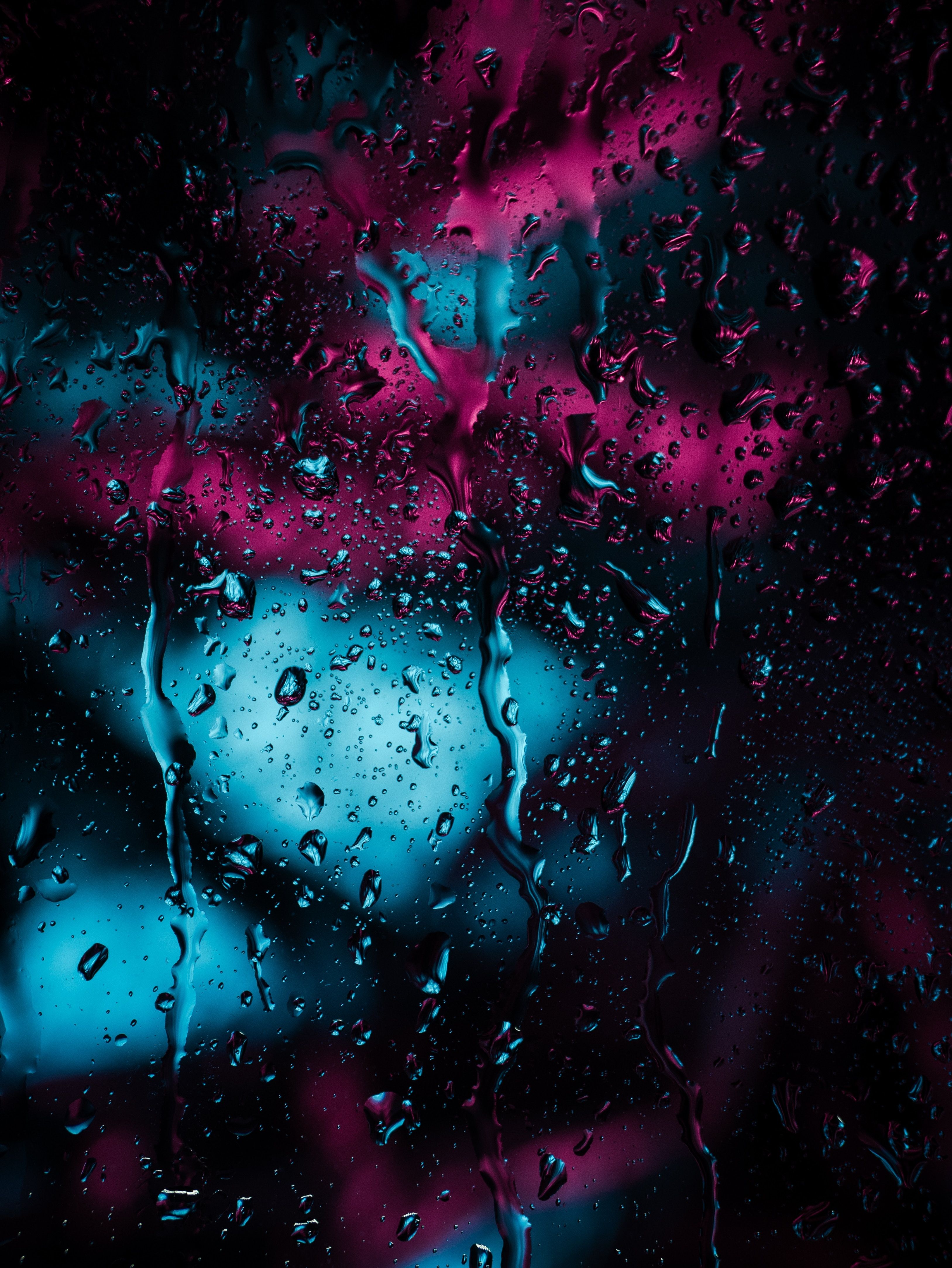 A water droplets on a glass with a dark background - Blurry, rain