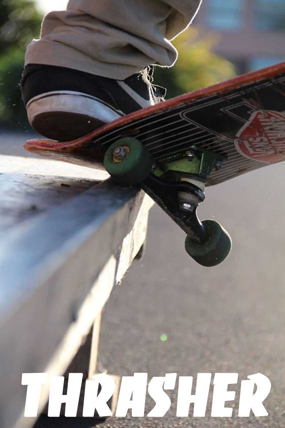 A skateboarder is doing tricks on the sidewalk - Skate