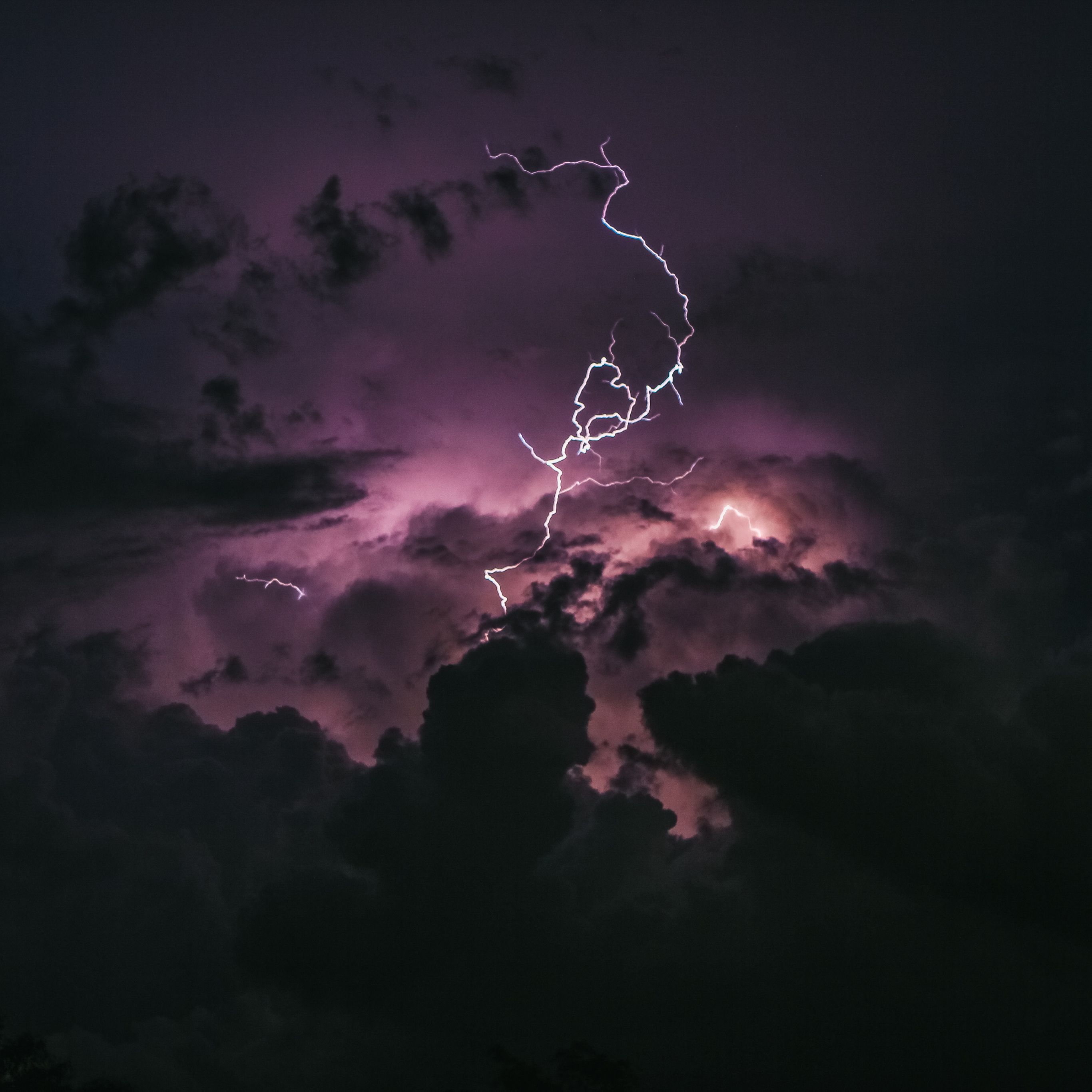 A purple lightning bolt strikes the sky - Apple Watch, lightning, storm