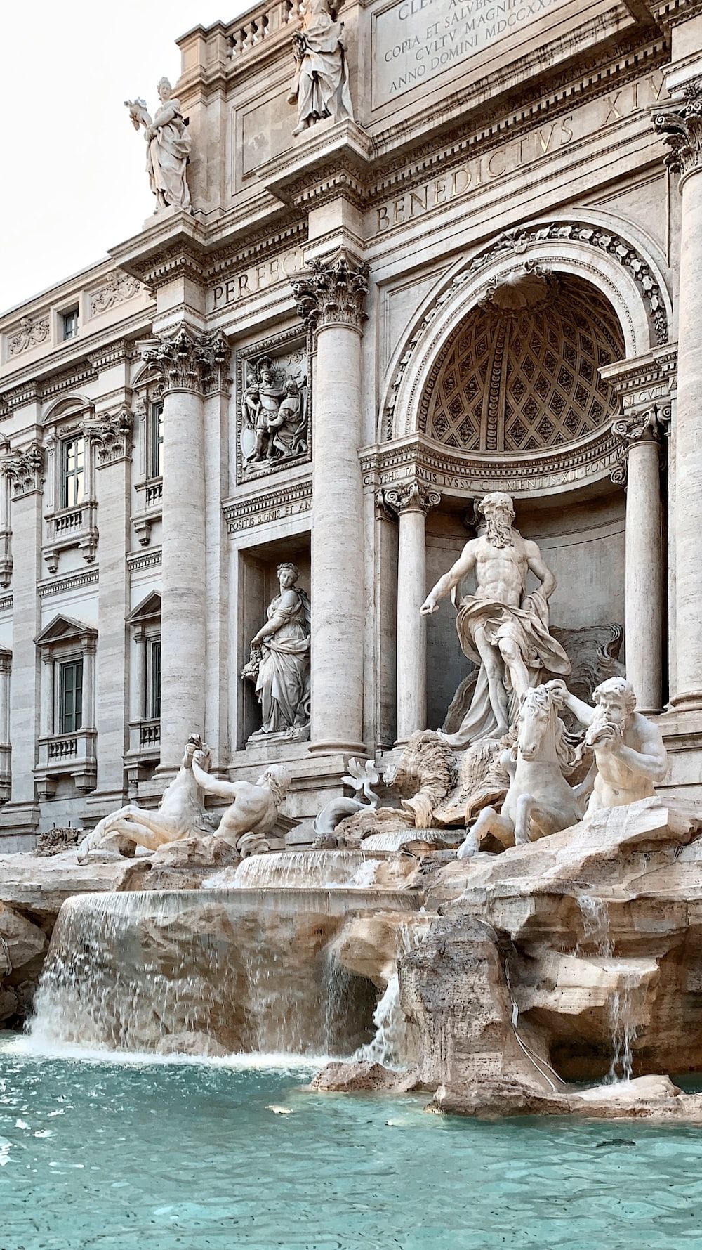 A large fountain in front of an old building - Italy