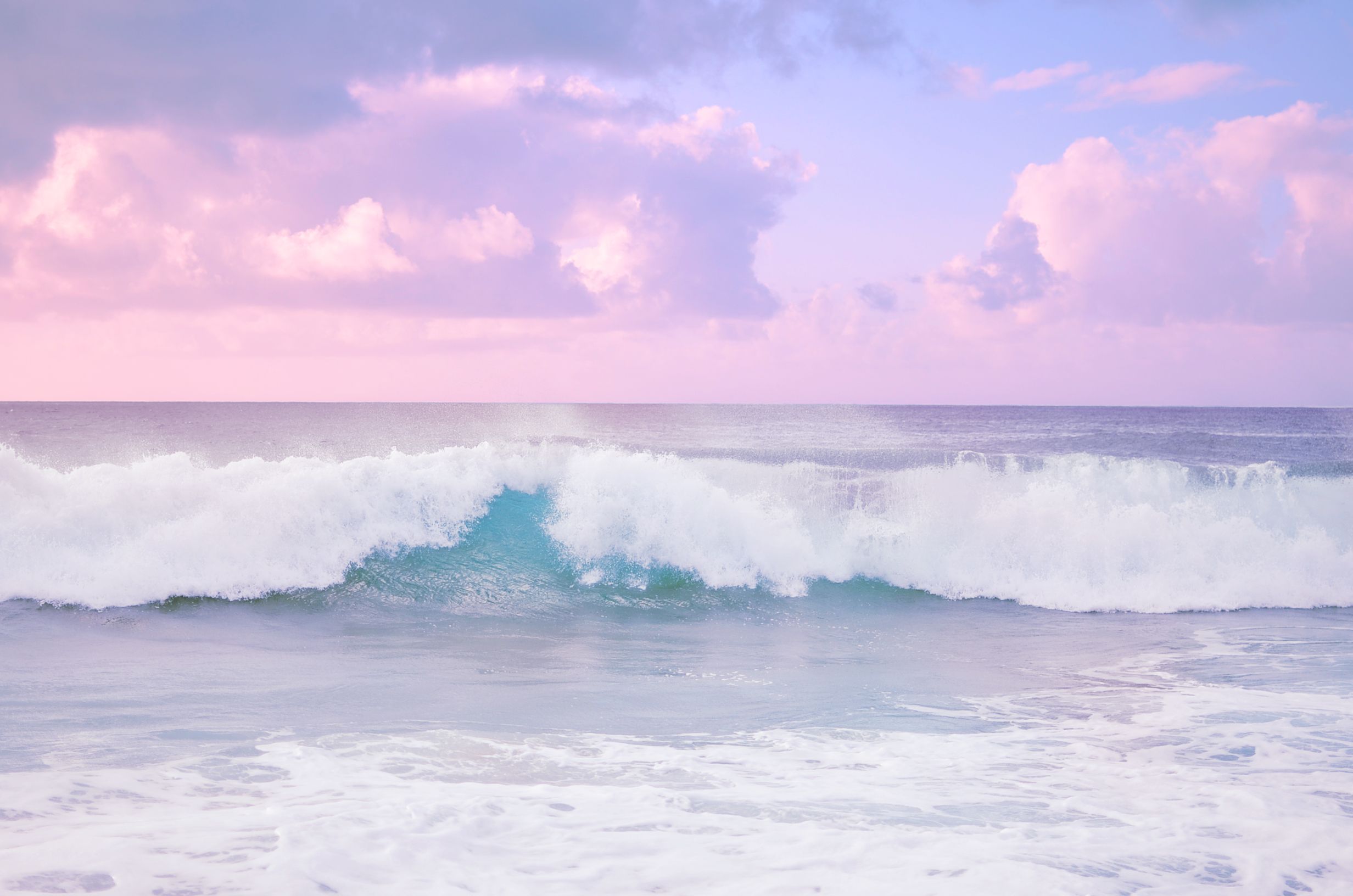 A wave crashes on the beach at sunset - Beach