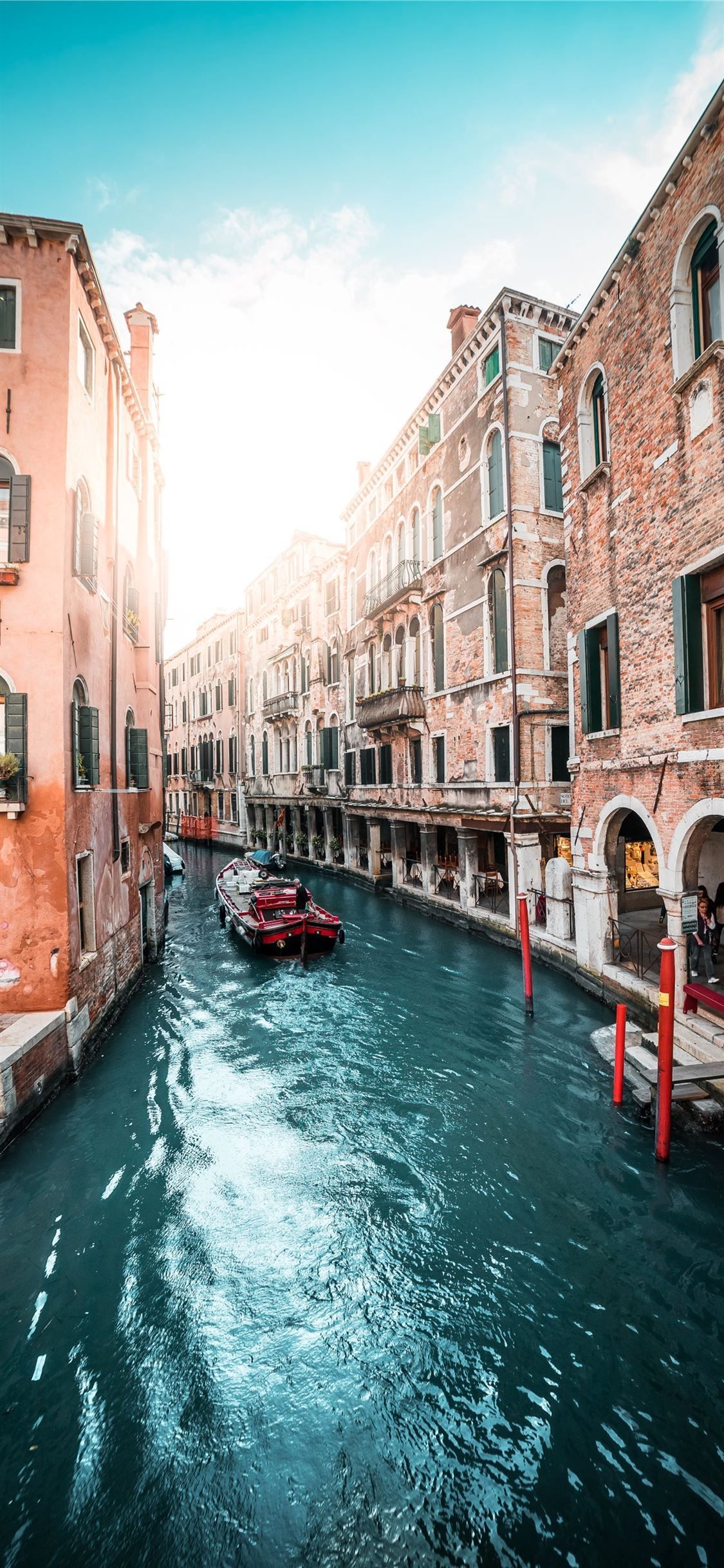 A canal with boats and buildings on either side - Italy