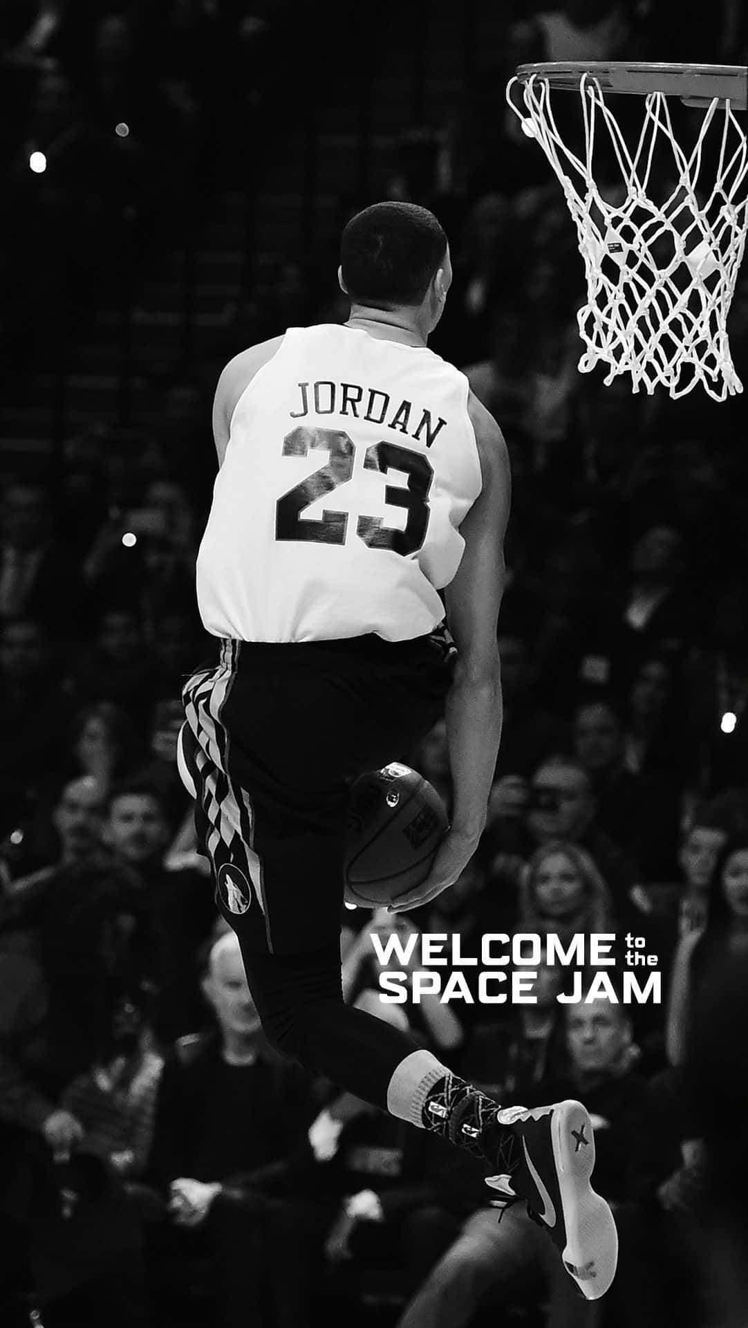 A black and white image of a basketball player in the middle of a dunk. - NBA