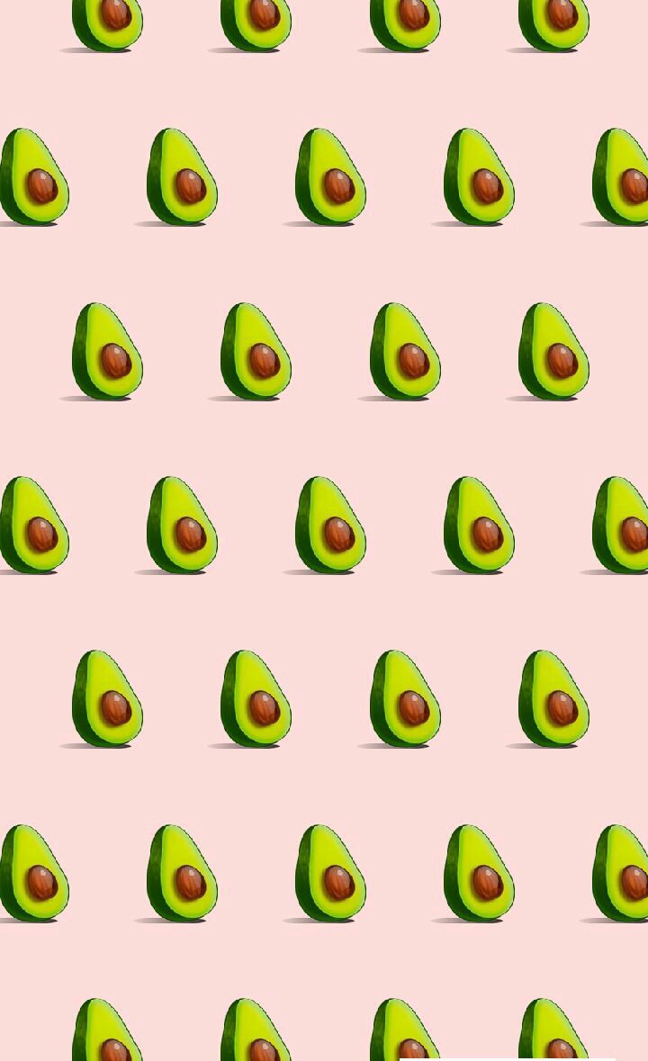 A pattern of avocado halves on a pink background - Avocado
