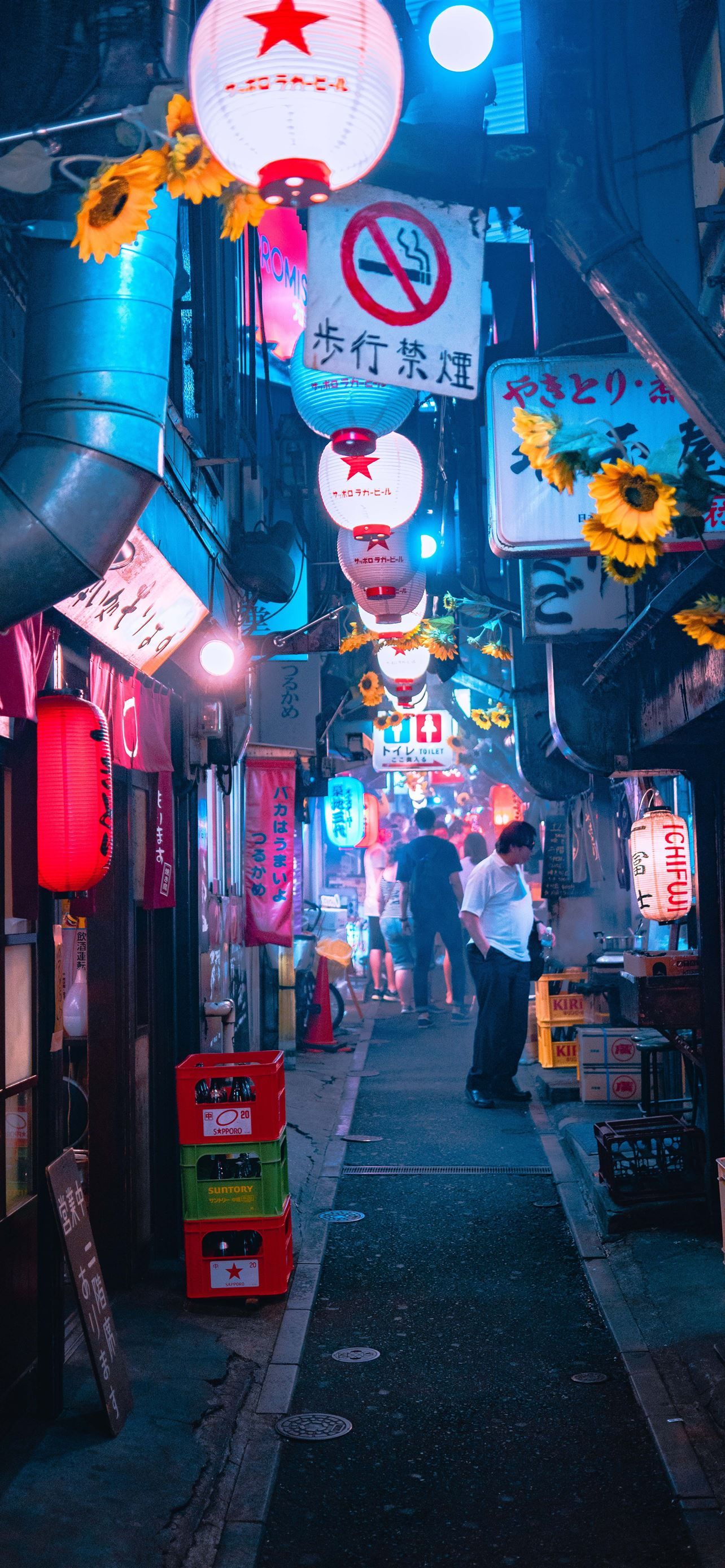 A dark alleyway with neon lights and signs. - Tokyo