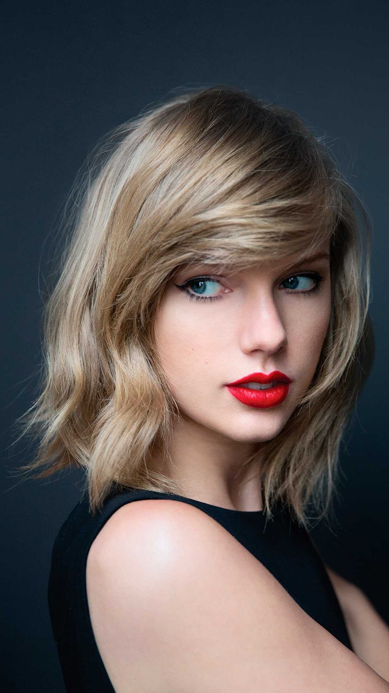 A woman with red lipstick and black dress - Taylor Swift