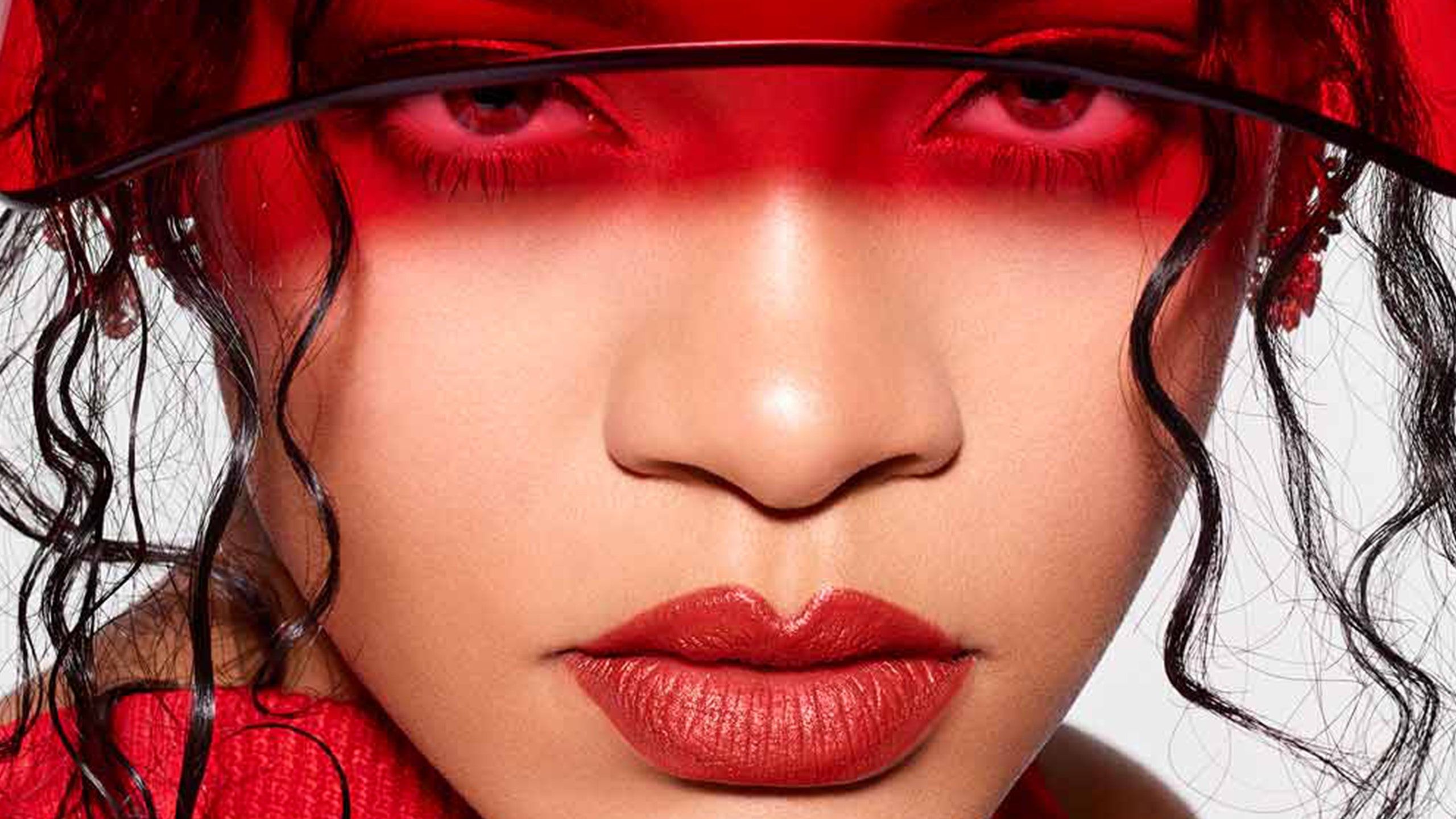 A woman wearing red lipstick and hat - Rihanna