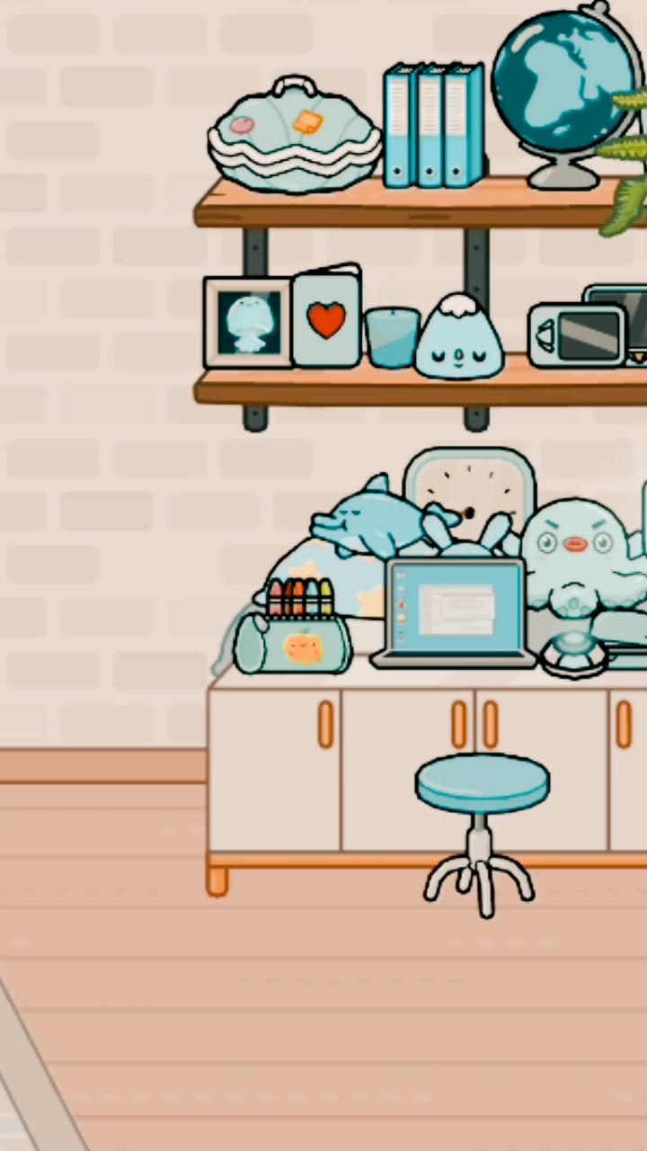 A blue bear is sitting on a desk with a laptop and a book. - Toca Boca