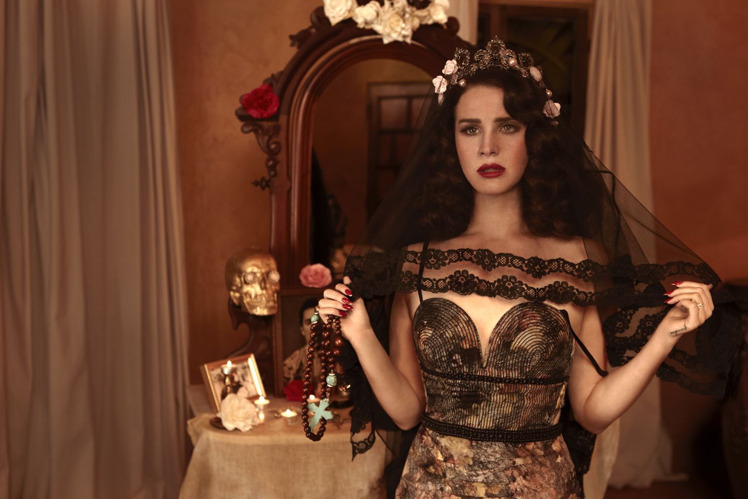 A woman in fancy dress standing by mirror - Lana Del Rey