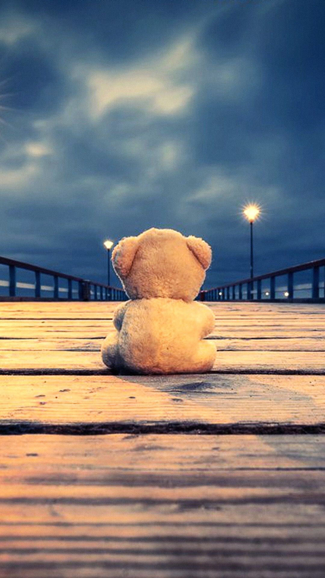 Teddy bear sitting alone on a pier - Teddy bear