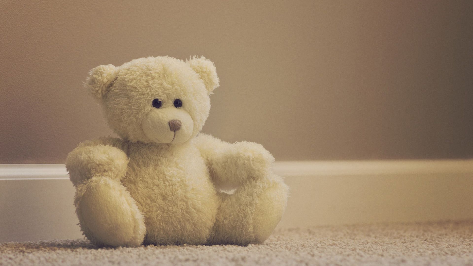 A teddy bear sitting on the floor - Teddy bear