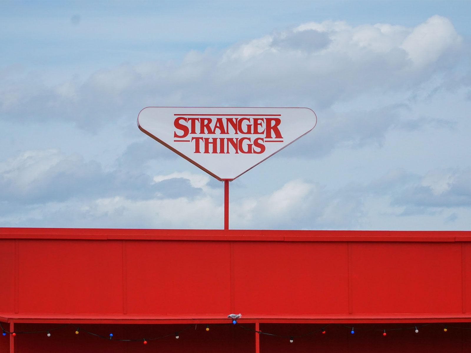 A red building with white letters on it - Stranger Things