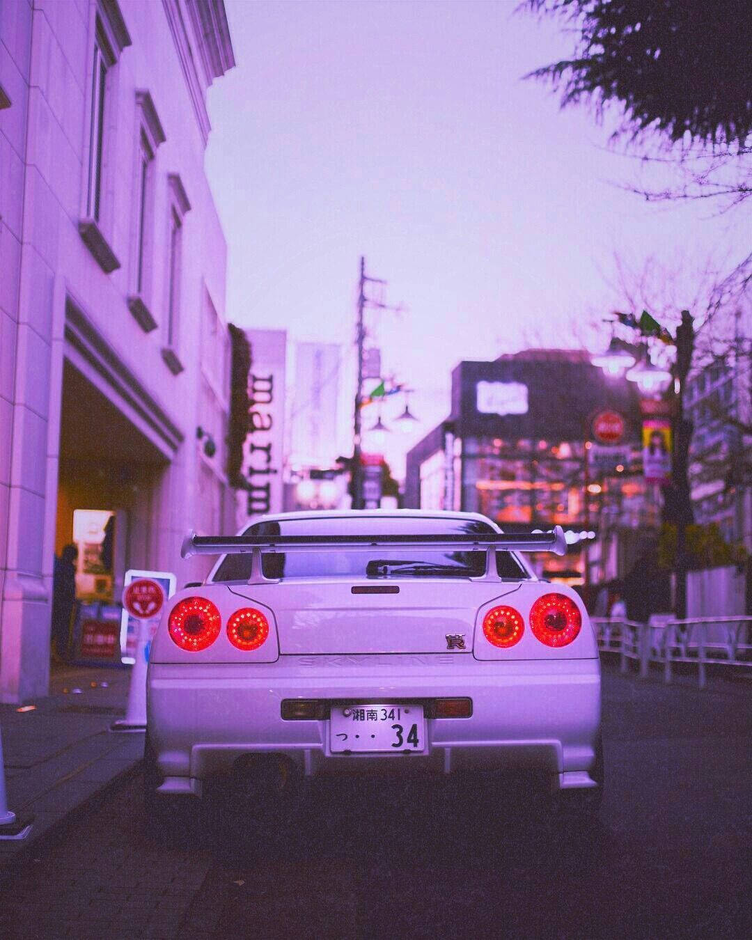 A car with the number 34 on the back parked on the street - Nissan Skyline, JDM, cars