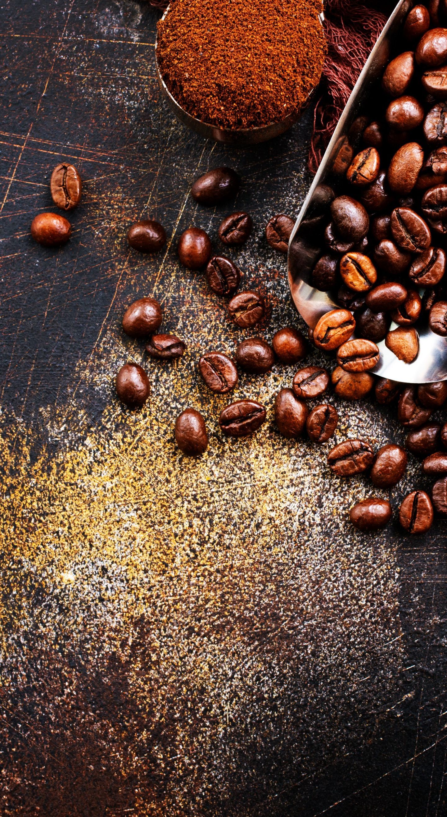 A spoon is scooping up some coffee beans - Coffee