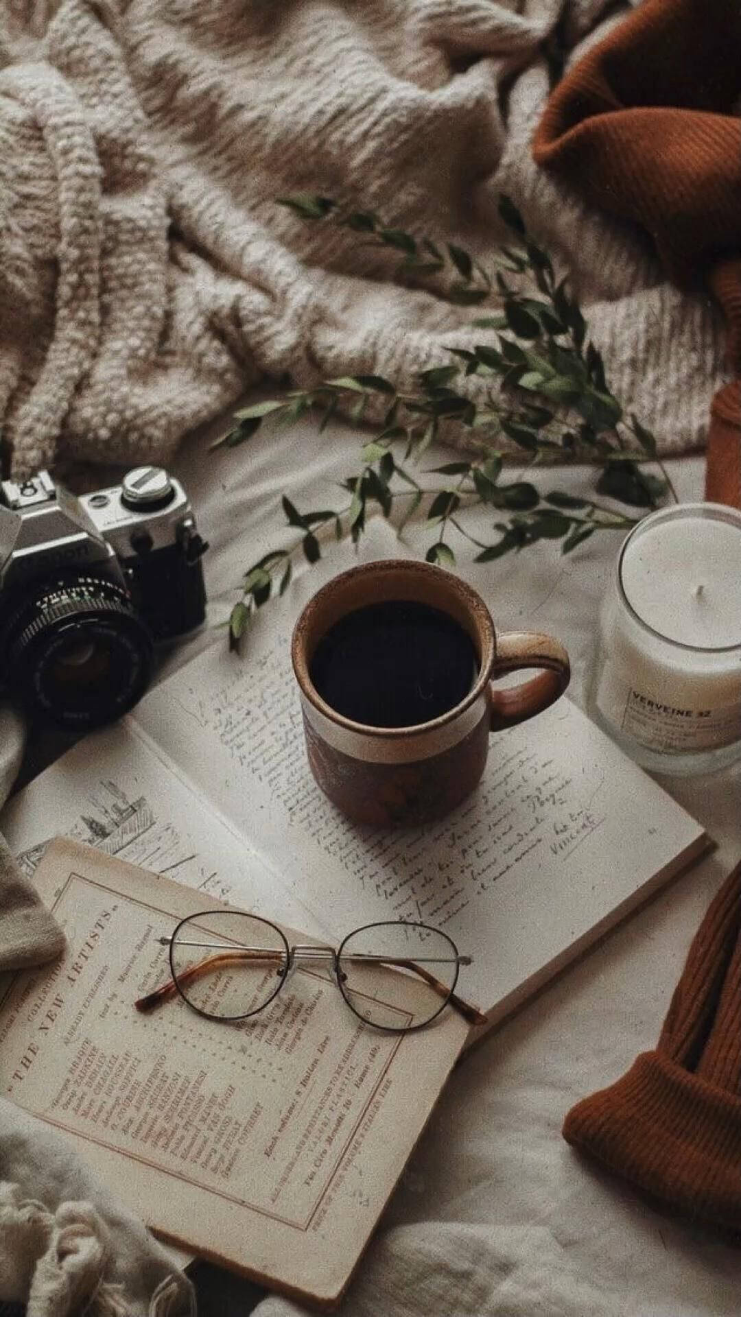 A cup of coffee on top of an open book - Coffee