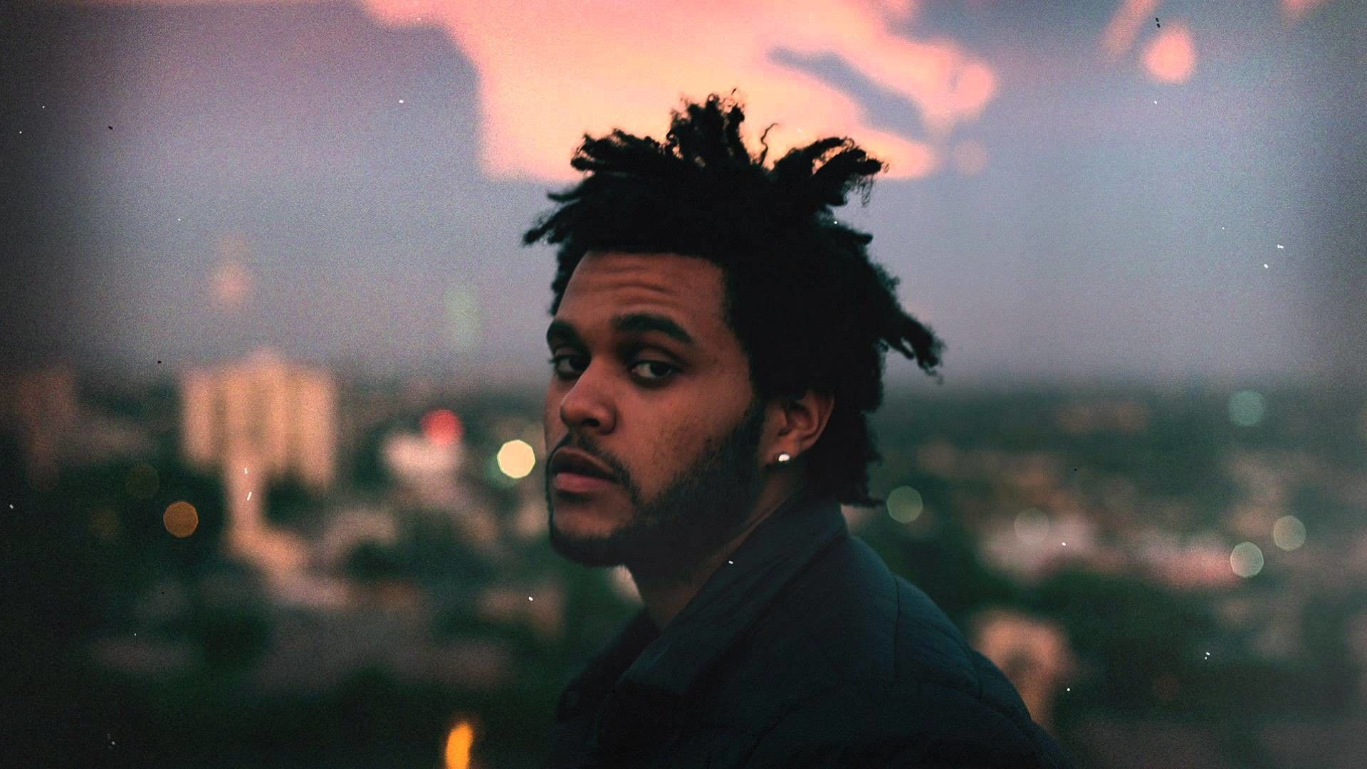 A man with dreadlocks is looking at the camera - The Weeknd