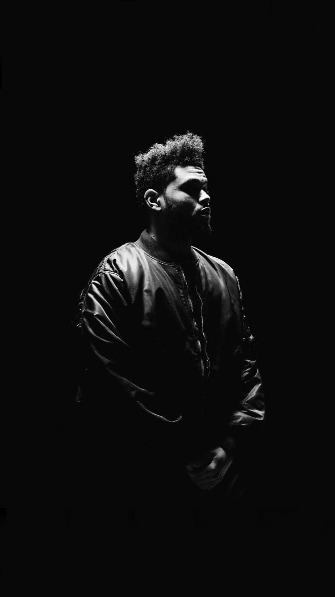 A man in black leather jacket standing alone - The Weeknd