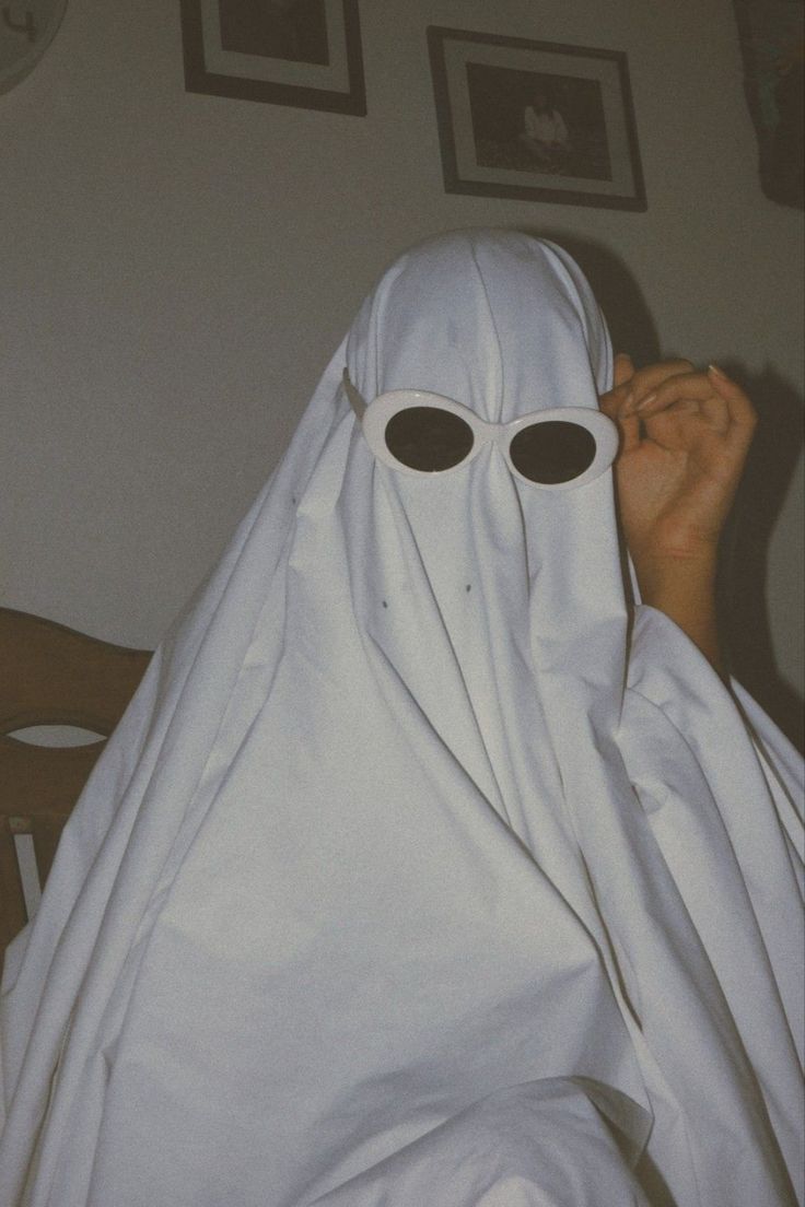 A person in white clothes and sunglasses - Ghost