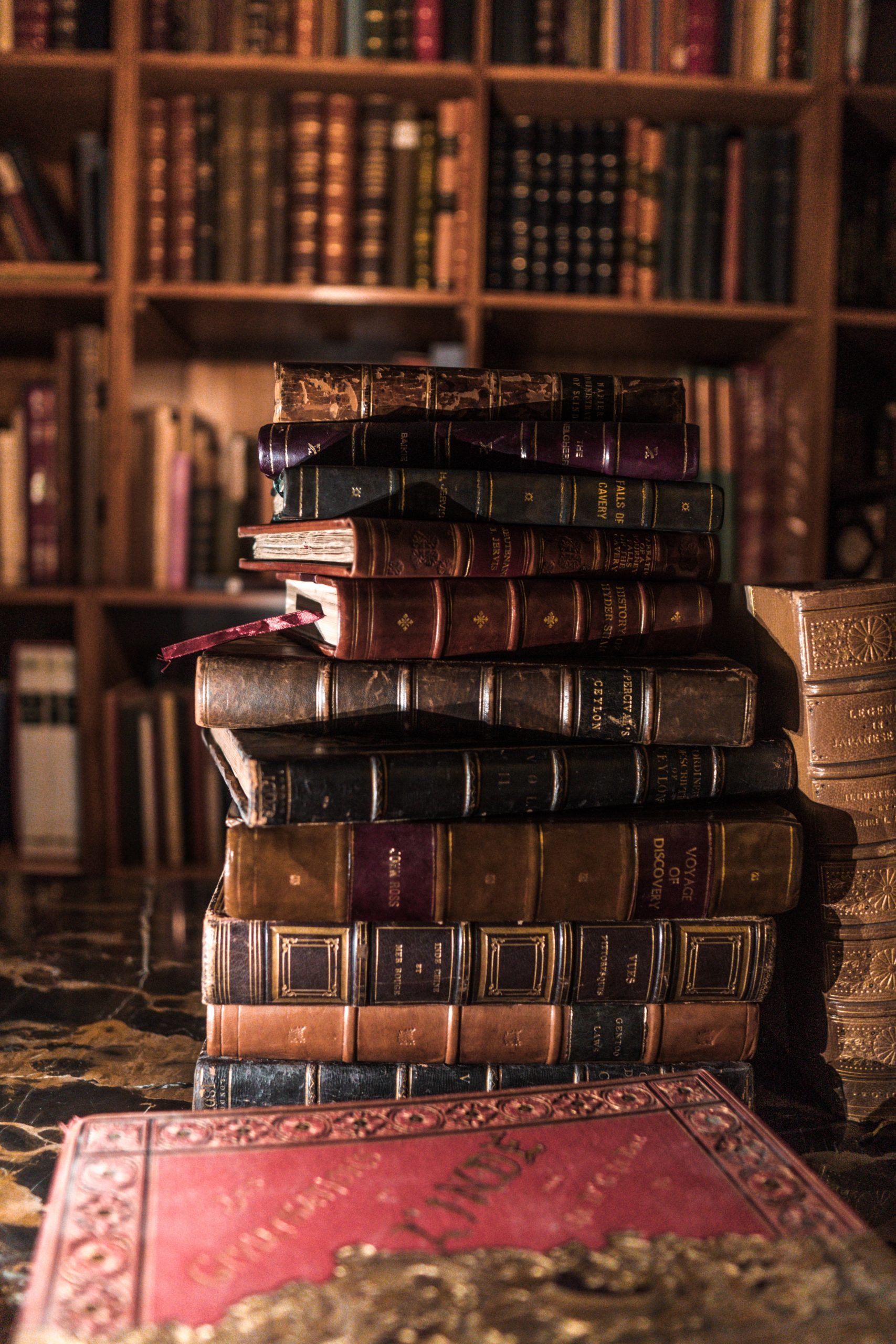 A stack of old books in a library - Bookshelf, books, dark academia, library